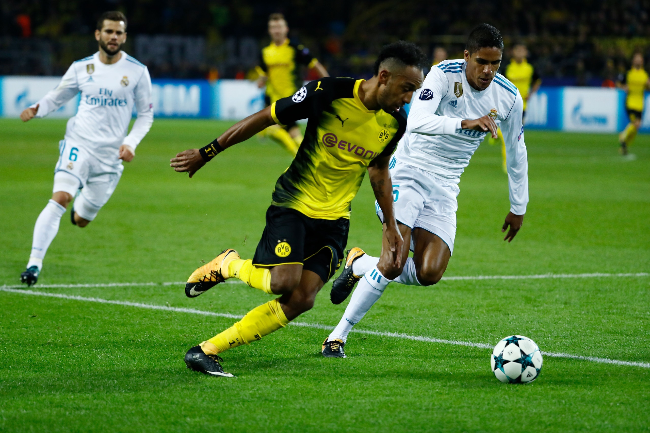 Dortmund's Gabonese forward Pierre-Emerick Aubameyang and Real Madrid's defender from France Raphael Varane vie for the ball during the UEFA Champions League Group H football match BVB Borussia Dortmund v Real Madrid in Dortmund, western Germany on Septem