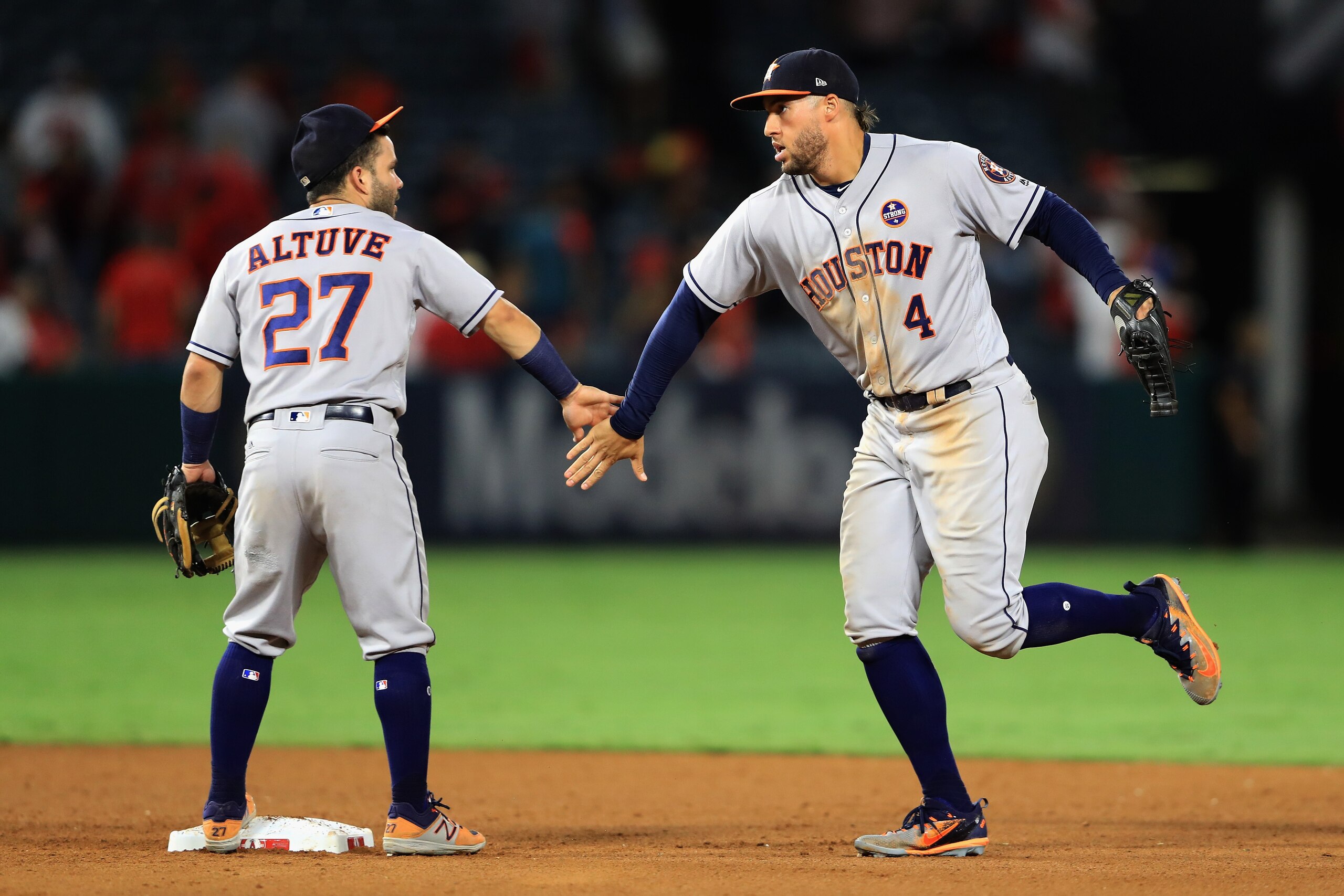 ANAHEIM, CA - SEPTEMBER 12:  Jose Altuve #27 and George Springer #4 of the Houston Astros celebrate defeating the Los Angeles Angels of Anaheim 1-0 in a game at Angel Stadium of Anaheim on September 12, 2017 in Anaheim, California.  (Photo by Sean M. Haff