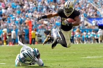 CHARLOTTE, NC - SEPTEMBER 24:  Mark Ingram #22 of the New Orleans Saints hurdles Daryl Worley #26 of the Carolina Panthers during their game at Bank of America Stadium on September 24, 2017 in Charlotte, North Carolina.  (Photo by Grant Halverson/Getty Im
