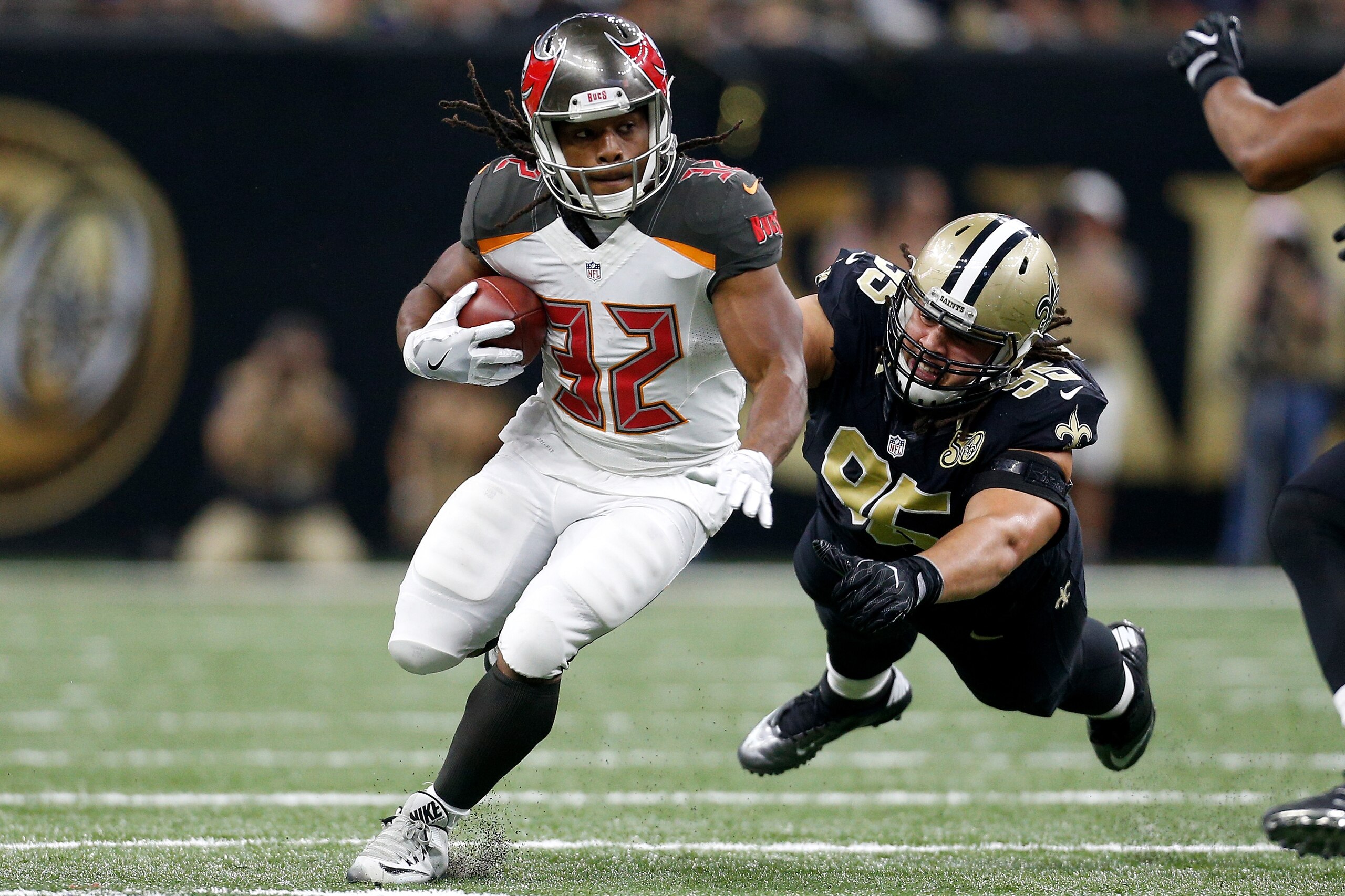 NEW ORLEANS, LA - DECEMBER 24:  Jacquizz Rodgers #32 of the Tampa Bay Buccaneers avoids a tackle by  Tyeler Davison #95 of the New Orleans Saints at the Mercedes-Benz Superdome on December 24, 2016 in New Orleans, Louisiana.  (Photo by Jonathan Bachman/Ge