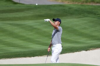 JERSEY CITY, NJ - SEPTEMBER 27:  Justin Thomas of the U.S. Team throws a ball during practice rounds prior to the Presidents Cup at Liberty National Golf Club on September 27, 2017 in Jersey City, New Jersey.  (Photo by Sam Greenwood/Getty Images)