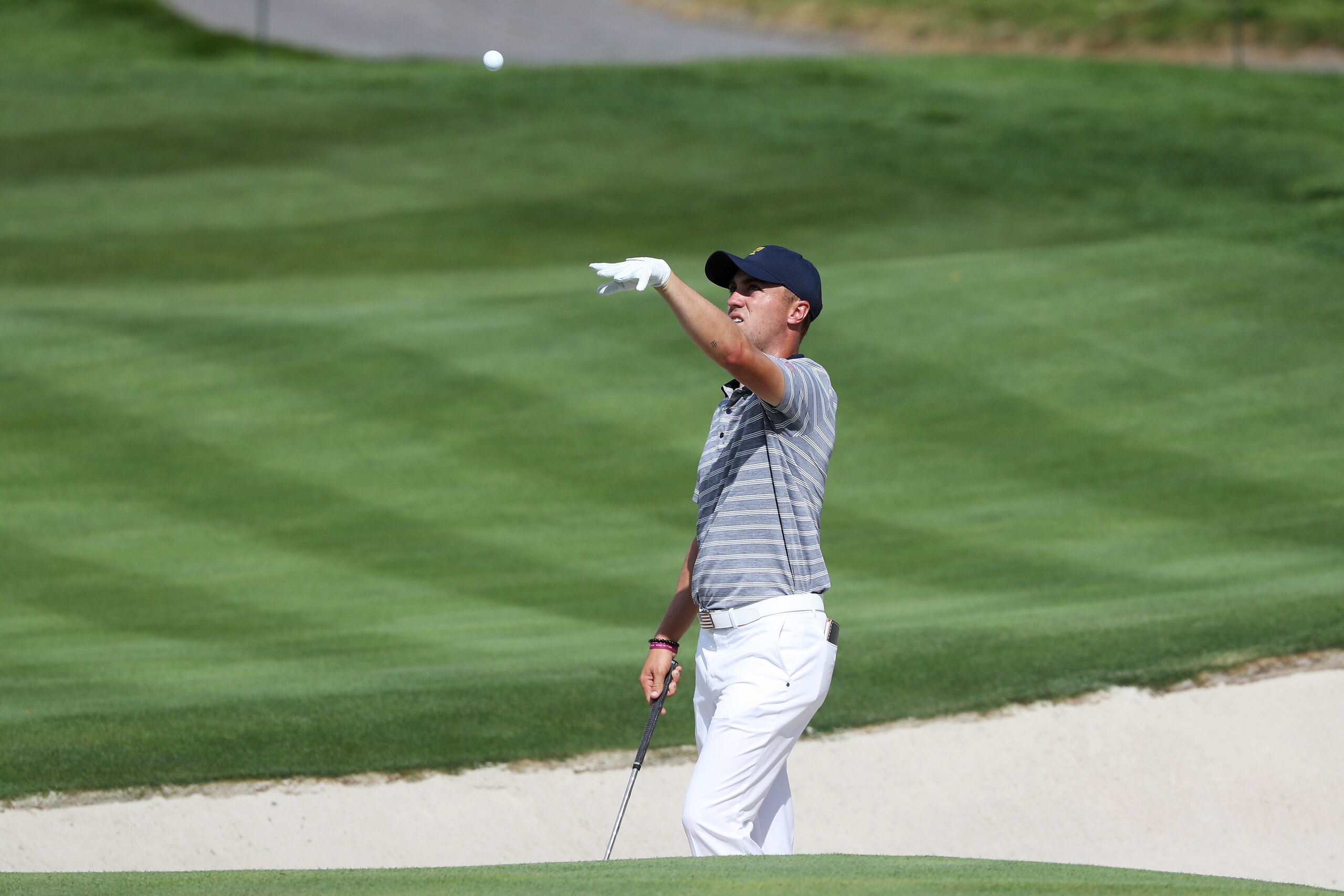JERSEY CITY, NJ - SEPTEMBER 27:  Justin Thomas of the U.S. Team throws a ball during practice rounds prior to the Presidents Cup at Liberty National Golf Club on September 27, 2017 in Jersey City, New Jersey.  (Photo by Sam Greenwood/Getty Images)