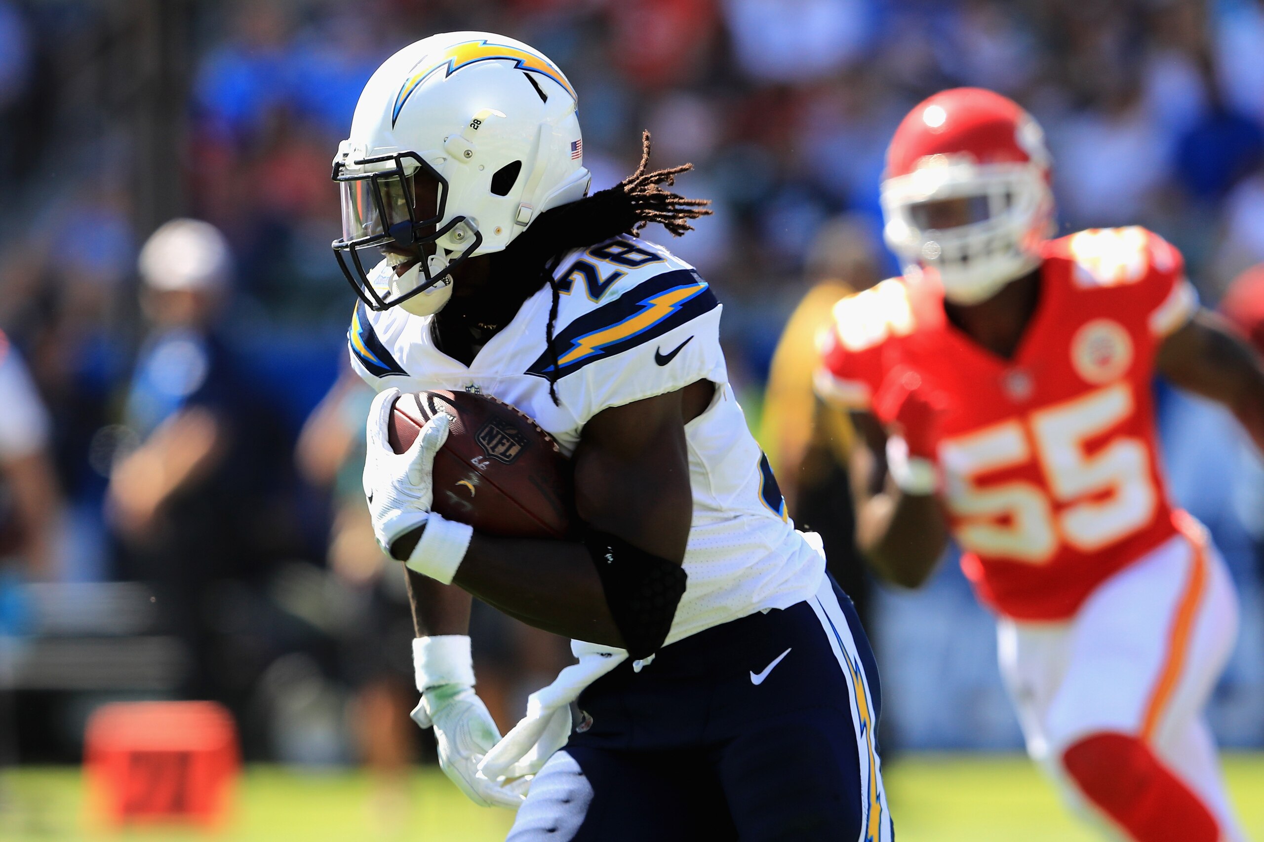 CARSON, CA - SEPTEMBER 24:   Melvin Gordon #28 of the Los Angeles Chargers eludes  Dee Ford #55 of the Kansas City Chiefs on a run play during the first half of a game at StubHub Center on September 24, 2017 in Carson, California.  (Photo by Sean M. Haffe