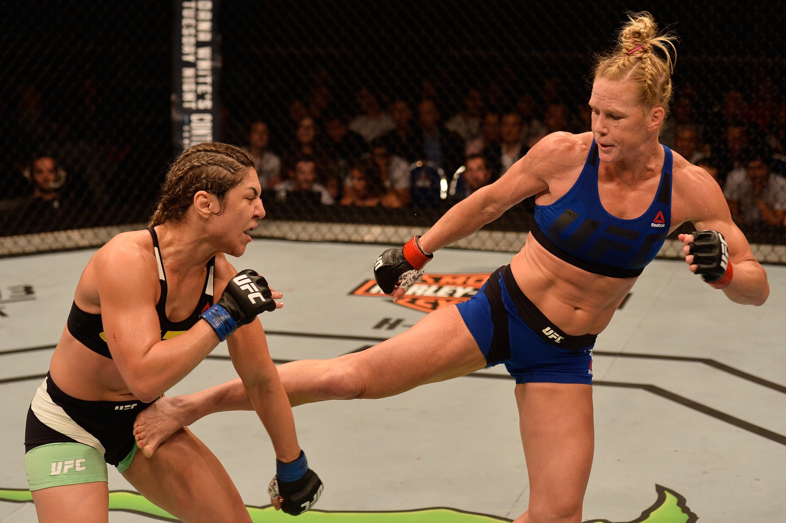 SINGAPORE - JUNE 17:   (R-L) Holly Holm kicks Bethe Correia of Brazil in their women's bantamweight bout during the UFC Fight Night event at the Singapore Indoor Stadium on June 17, 2017 in Singapore. (Photo by Brandon Magnus/Zuffa LLC/Zuffa LLC via Getty