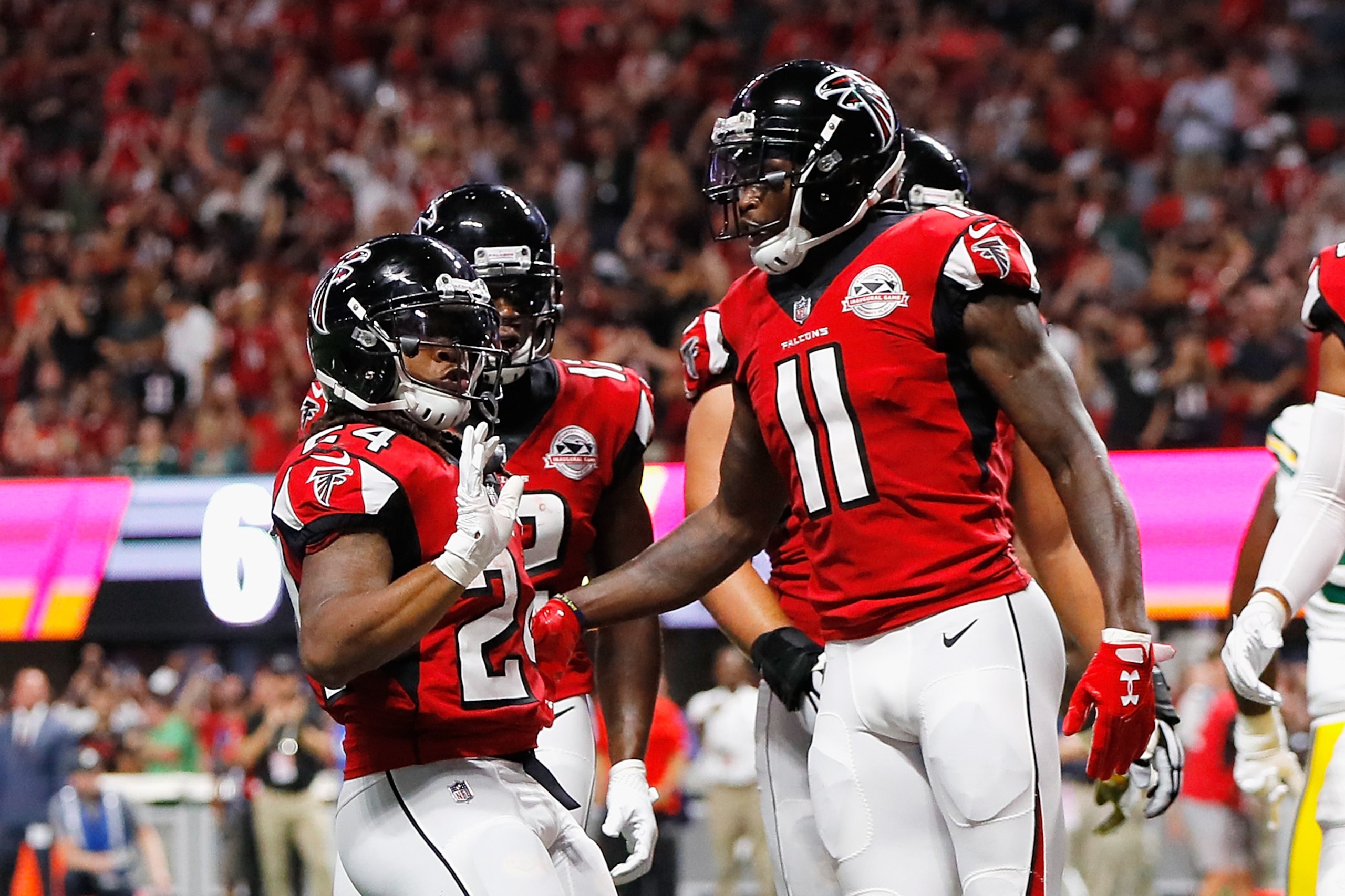 ATLANTA, GA - SEPTEMBER 17:  Devonta Freeman #24 of the Atlanta Falcons celebrates with Julio Jones #11 after scoring a 1-yard rushing touchdown during the first quarter against the Green Bay Packers at Mercedes-Benz Stadium on September 17, 2017 in Atlan
