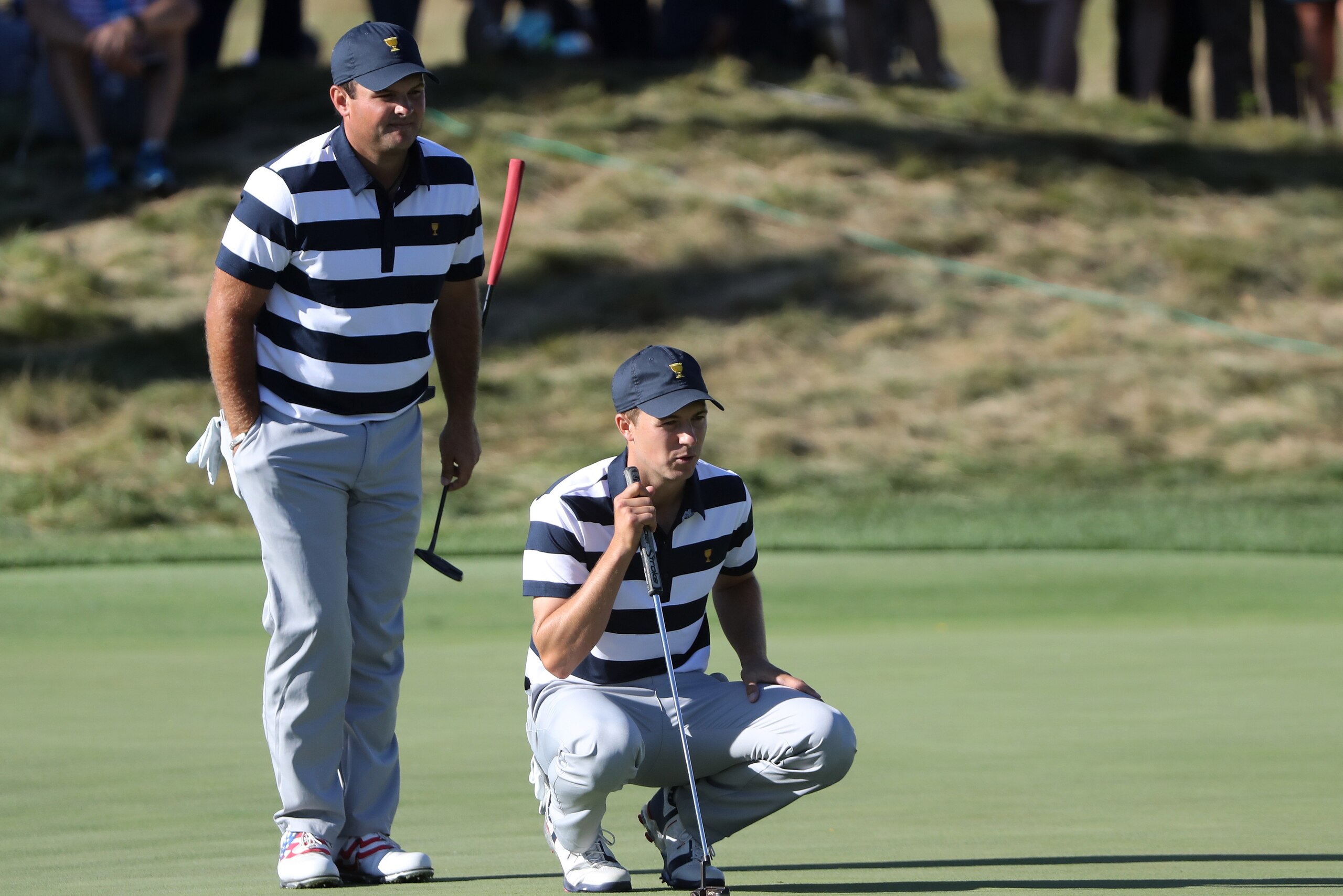 JERSEY CITY, NJ - SEPTEMBER 28:  Patrick Reed and Jordan Spieth of the U.S. Team line up a putt during Thursday foursome matches of the Presidents Cup at Liberty National Golf Club on September 28, 2017 in Jersey City, New Jersey.  (Photo by Sam Greenwood