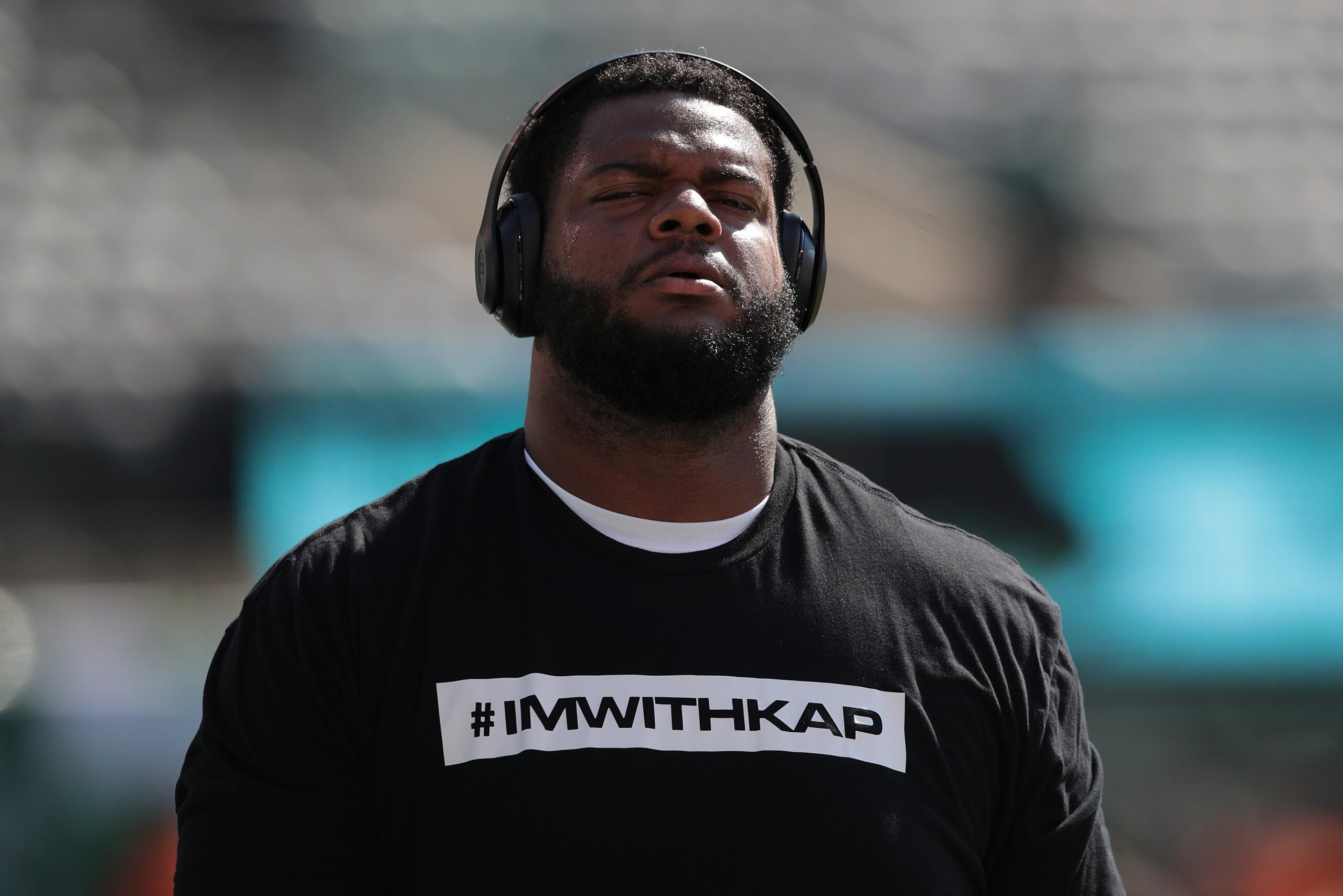 EAST RUTHERFORD, NJ - SEPTEMBER 24: Jordan Phillips #97 of the Miami Dolphins wears a t-shirt in support of former quarterback Colin Kaepernick before a game against of the New York Jets at MetLife Stadium on September 24, 2017 in East Rutherford, New Jer EAST RUTHERFORD, NJ - SEPTEMBER 24: Jordan Phillips #97 of the Miami Dolphins wears a t-shirt in support of former quarterback Colin Kaepernick before a game against of the New York Jets at MetLife Stadium on September 24, 2017 in East Rutherford, New Jer