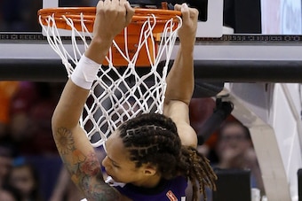 Brittney Griner dunks with two hands.