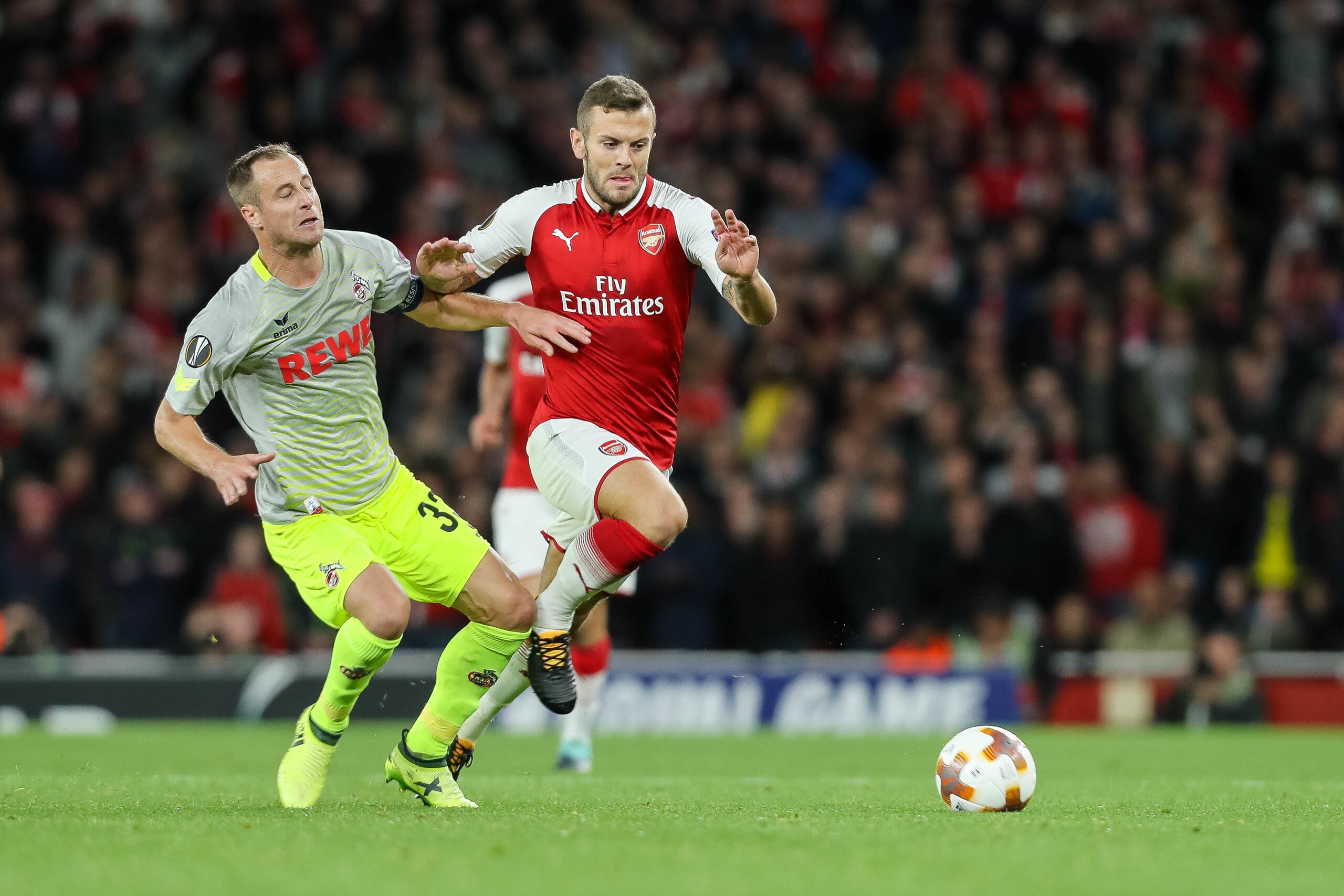 LONDON, ENGLAND - SEPTEMBER 14: Matthias Lehmann of FC Koeln and Jack Wilshere of Arsenal battle for the ball during the UEFA Europa League group H match between Arsenal FC and 1. FC Koeln at Emirates Stadium on September 14, 2017 in London, United Kingdo