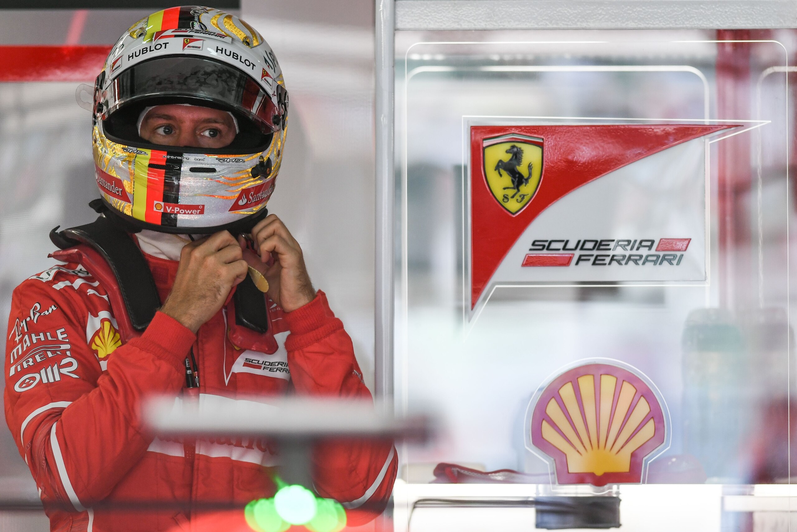 Ferrari's German driver Sebastian Vettel wears his helmet during the third practice session of the Formula One Malaysia Grand Prix in Sepang on September 30, 2017.  / AFP PHOTO / MOHD RASFAN        (Photo credit should read MOHD RASFAN/AFP/Getty Images)