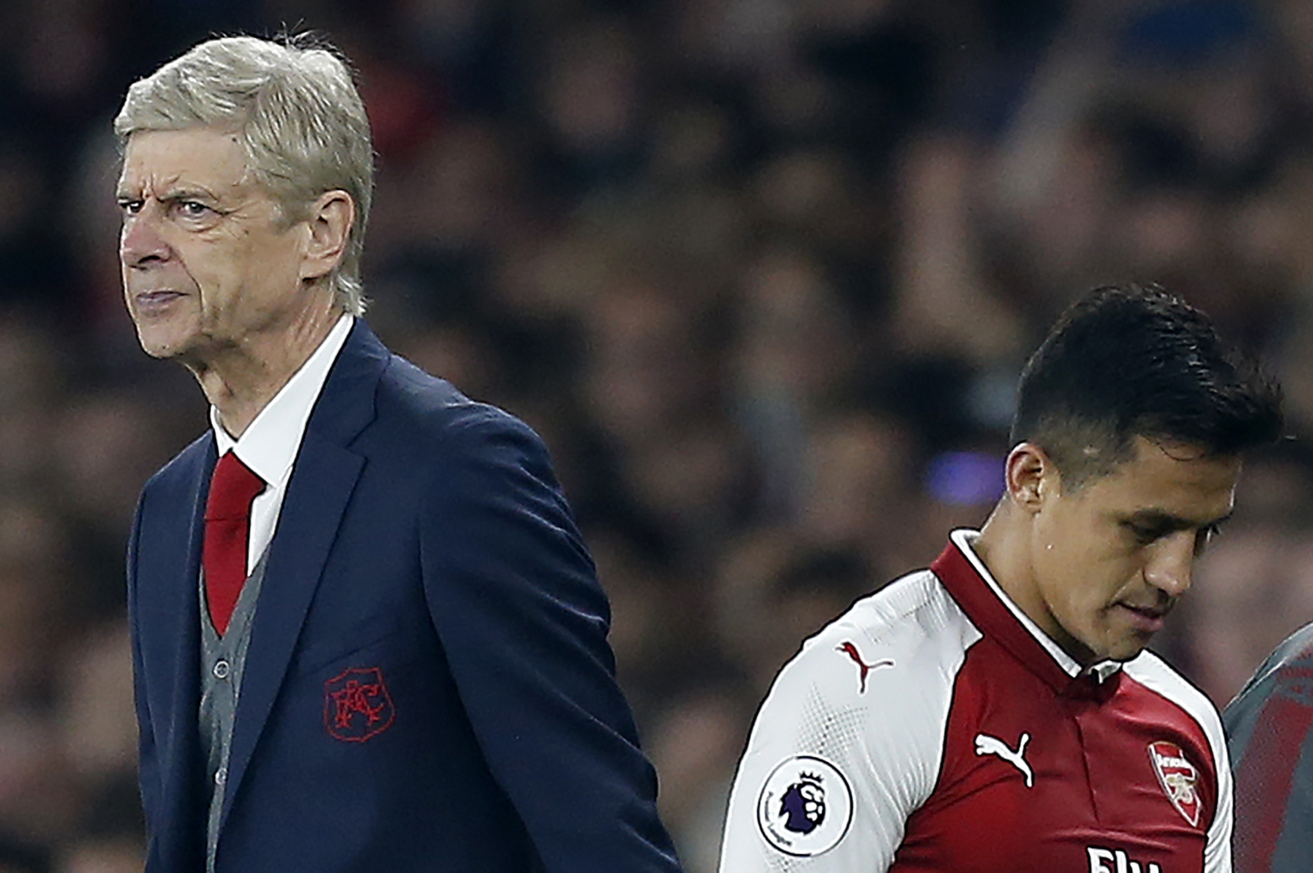 Arsenal's French manager Arsene Wenger (L) reacts as Arsenal's Chilean striker Alexis Sanchez is substituted off of the pitch during the English Premier League football match between Arsenal and West Bromwich Albion at the Emirates Stadium in London on Se