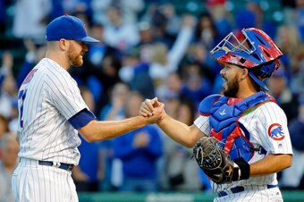 CHICAGO, IL - SEPTEMBER 30: Wade Davis #71 of the Chicago Cubs (L) and Eugenio Suarez #7 celebrate their win over the Cincinnati Reds at Wrigley Field on September 30, 2017 in Chicago, Illinois. The Chicago Cubs won 9-0. (Photo by Jon Durr/Getty Images)