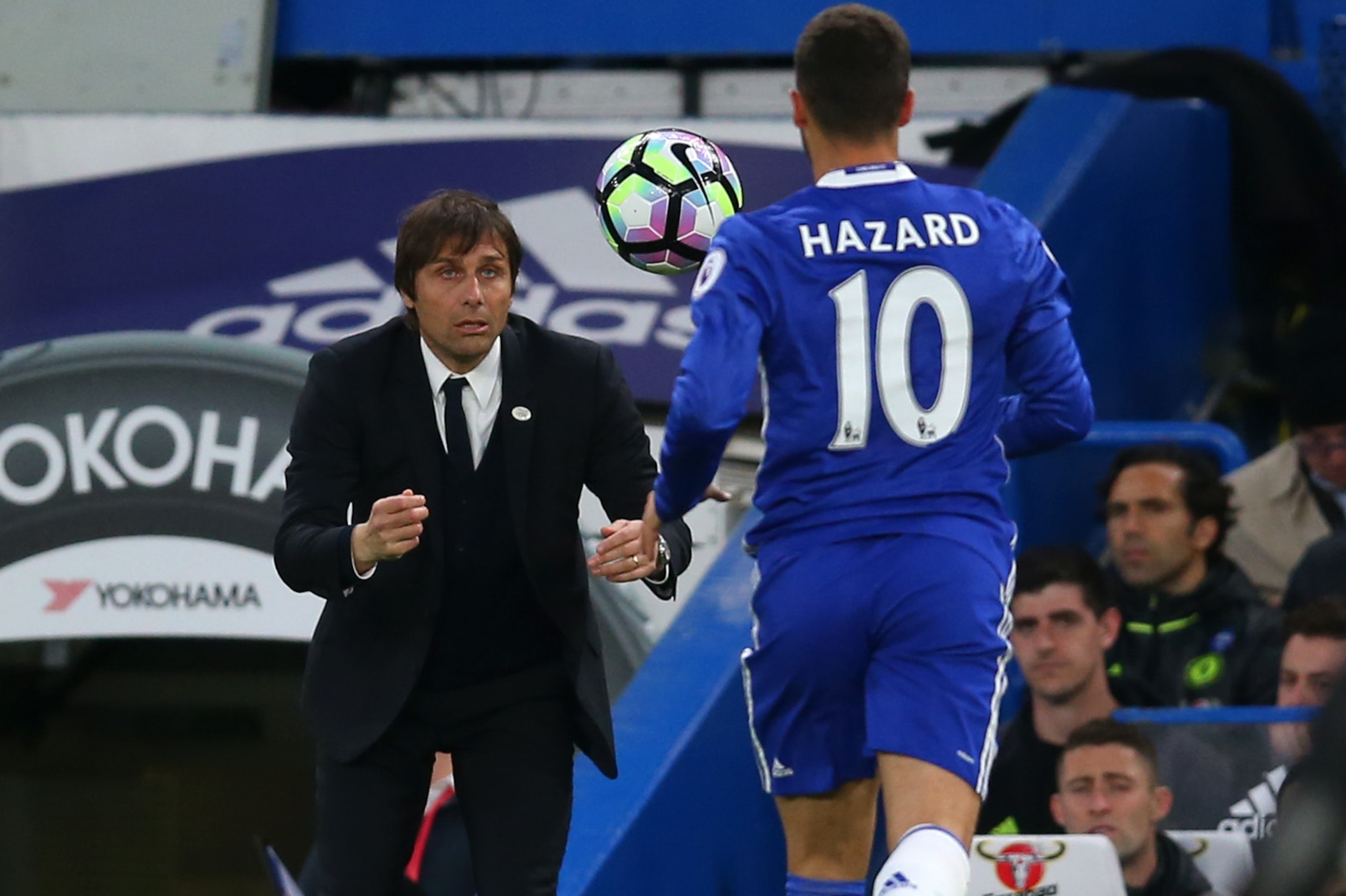 LONDON, ENGLAND - MAY 15: Antonio Conte manager / head coach of Chelsea throws the ball to Eden Hazard of Chelsea during the Premier League match between Chelsea and Watford at Stamford Bridge on May 15, 2017 in London, England. (Photo by Catherine Ivill 