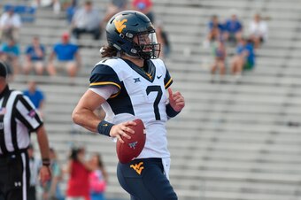 LAWRENCE, KS - SEPTEMBER 23: Will Grier #7 of the West Virginia Mountaineers runs for a touchdown against the Kansas Jayhawks at Memorial Stadium on September 23, 2017 in Lawrence, Kansas. (Photo by Ed Zurga/Getty Images)
