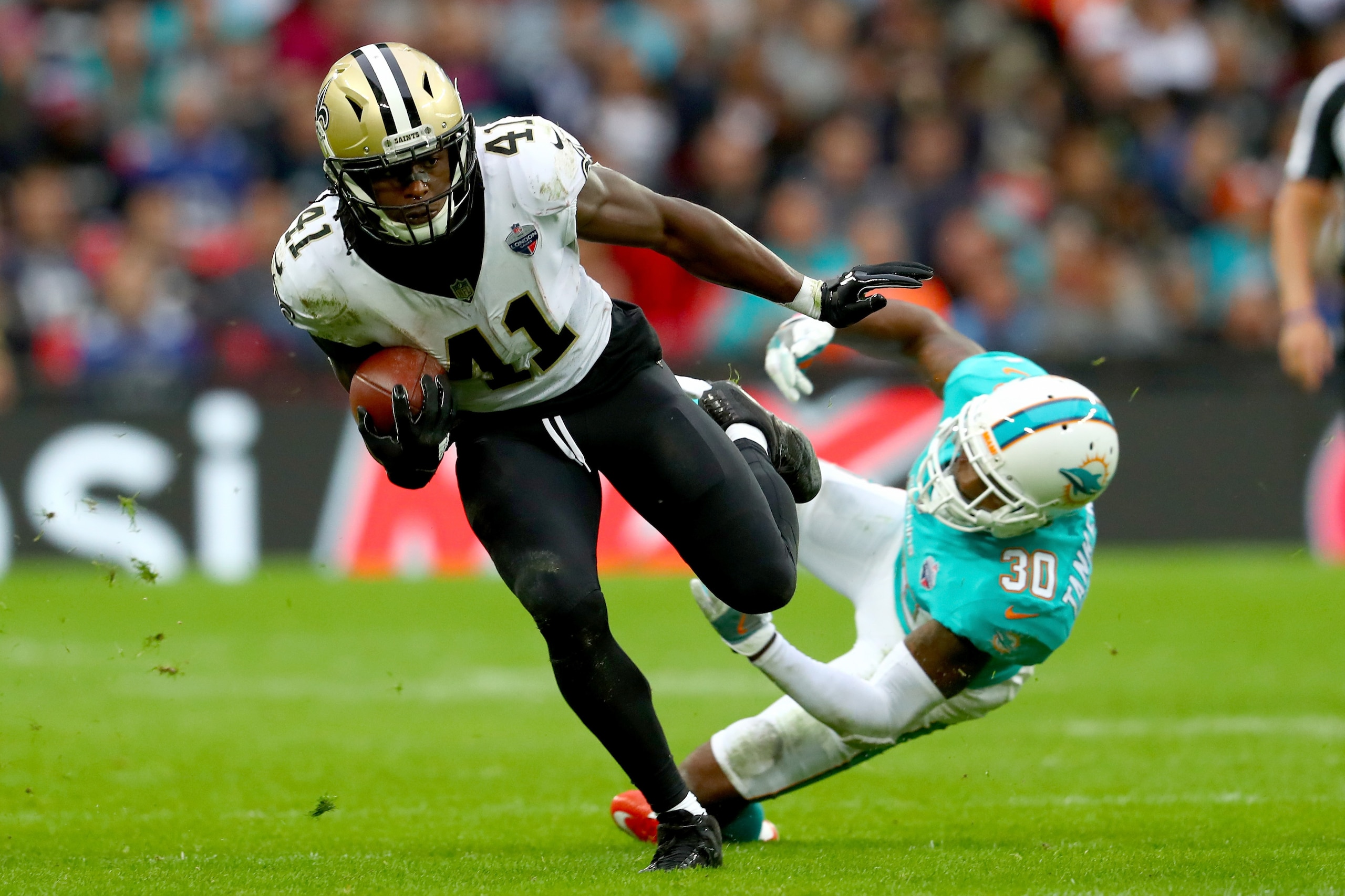 LONDON, ENGLAND - OCTOBER 01:  Alvin Kamara of the New Orleans Saints is challenged by Cordrea Tankersley of Miami Dolphins during the NFL match between New Orleans Saints and Miami Dolphins at Wembley Stadium on October 1, 2017 in London, England.  (Phot