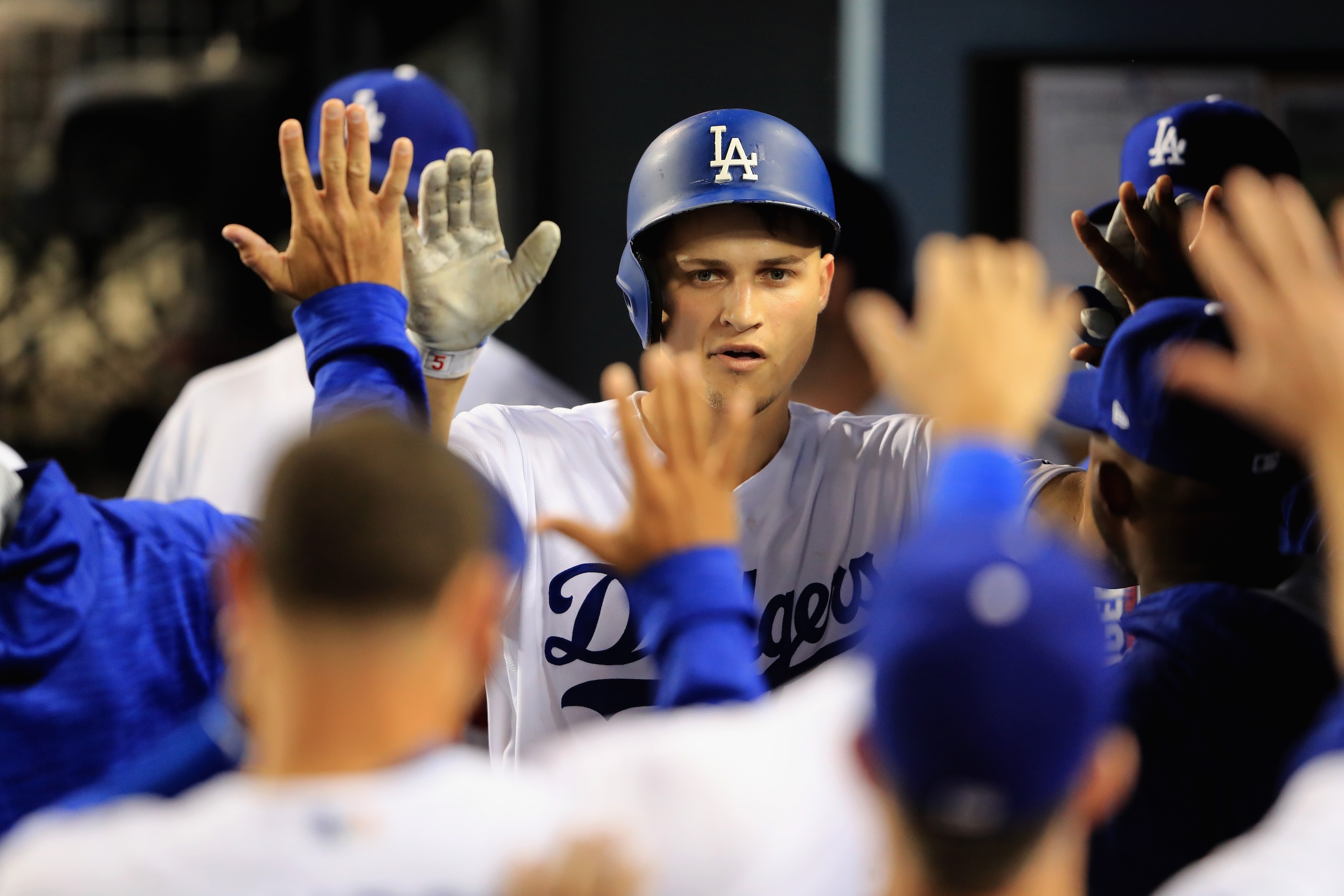 LOS ANGELES, CA - SEPTEMBER 27:  Corey Seager #5 of the Los Angeles Dodgers is congratulated in the dugout after hitting a solo homerun during the sixth inning of a game against the San Diego Padres  at Dodger Stadium on September 27, 2017 in Los Angeles,
