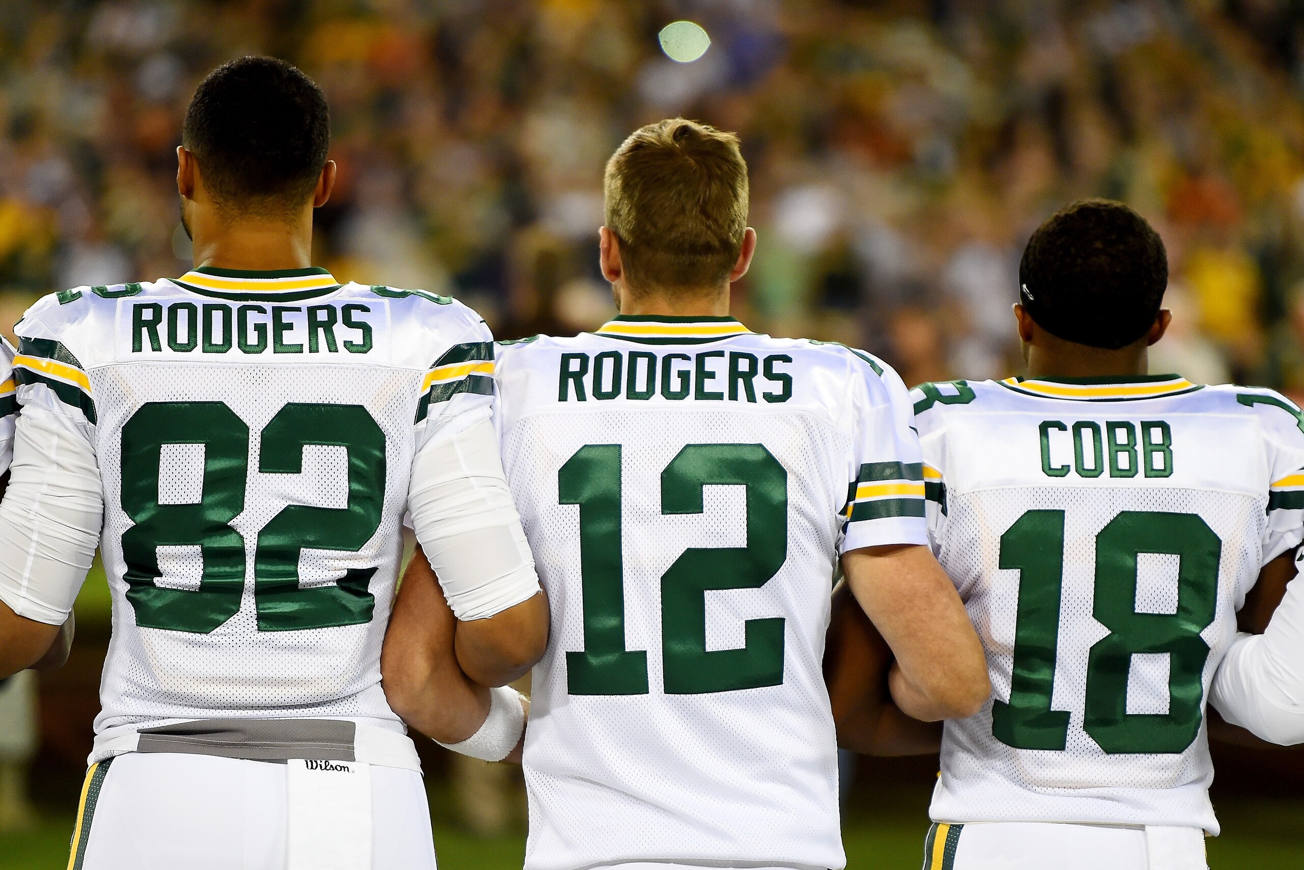 GREEN BAY, WI - SEPTEMBER 28:  Richard Rodgers #82, Aaron Rodgers #12 , and Randall Cobb #18 of the Green Bay Packers link arms during the singing of the national anthem before the game against the Chicago Bears at Lambeau Field on September 28, 2017 in G