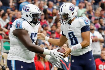 HOUSTON, TX - OCTOBER 01:  Marcus Mariota #8 of the Tennessee Titans celebrates with Quinton Spain #67 after a touchdown in the second quarter against the Houston Texans at NRG Stadium on October 1, 2017 in Houston, Texas.  (Photo by Tim Warner/Getty Imag
