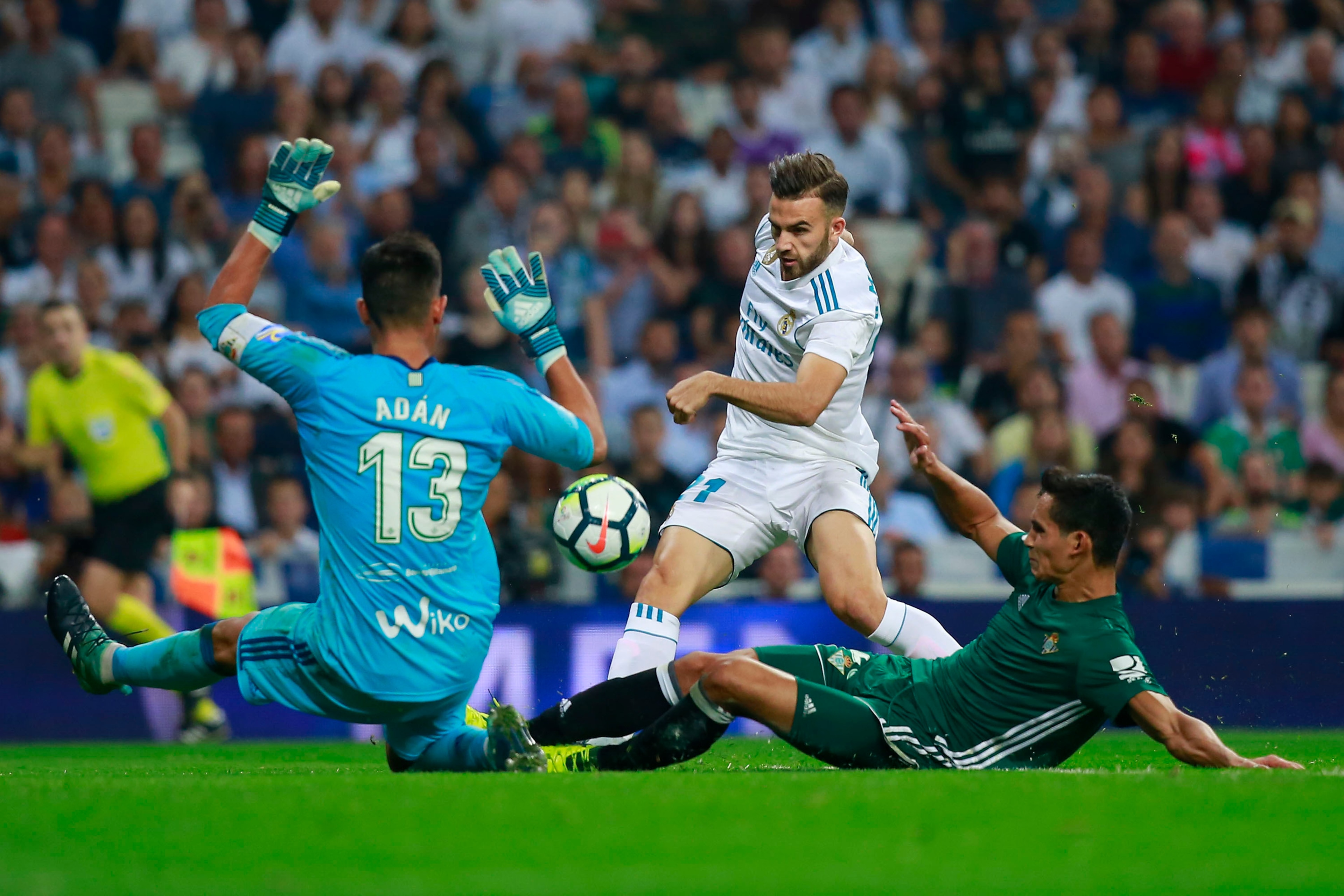 MADRID, SPAIN - SEPTEMBER 20: Borja Mayoral (2ndR) of Real Madrid CF strikes the ball behind goalkeeper Antonio Adan (L) of Real Betis Balompie during the La Liga match between Real Madrid CF and Real Betis Balompie at Estadio Santiago Bernabeu on Septemb