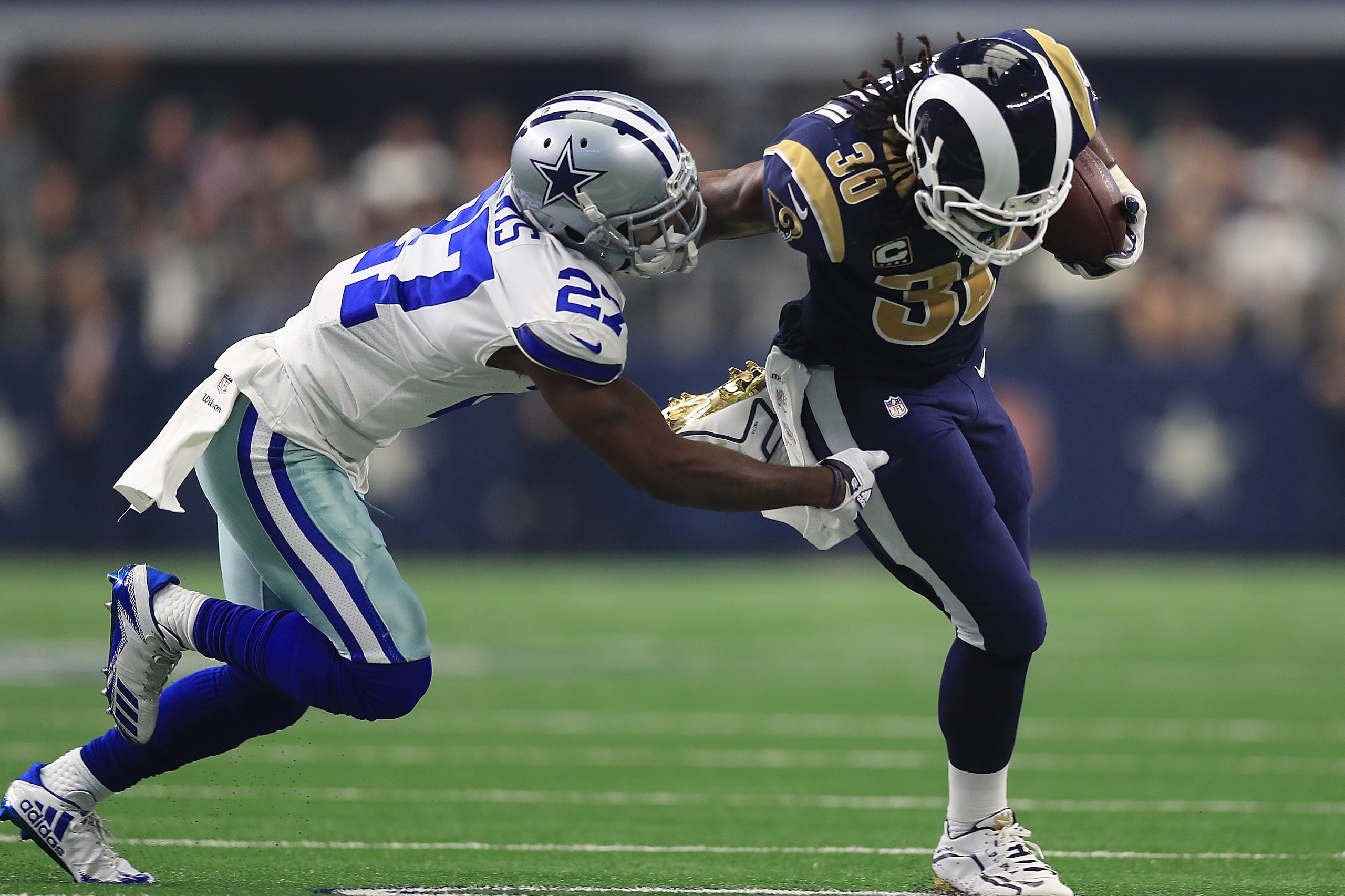ARLINGTON, TX - OCTOBER 01:  Jourdan Lewis #27 of the Dallas Cowboys pursues Todd Gurley #30 of the Los Angeles Rams in the first half of a game  at AT&T Stadium on October 1, 2017 in Arlington, Texas.  (Photo by Ronald Martinez/Getty Images)