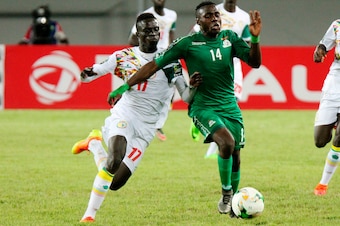 Zambia's Edward Chilufya (R) is tackled by Senegals's Krepin Diatta (L) during the African Cup of Nations Under 20 football match Zambia against Senegal in Lusaka on March 12, 2017.  / AFP PHOTO / DAWOOD SALIM        (Photo credit should read DAWOOD SALIM