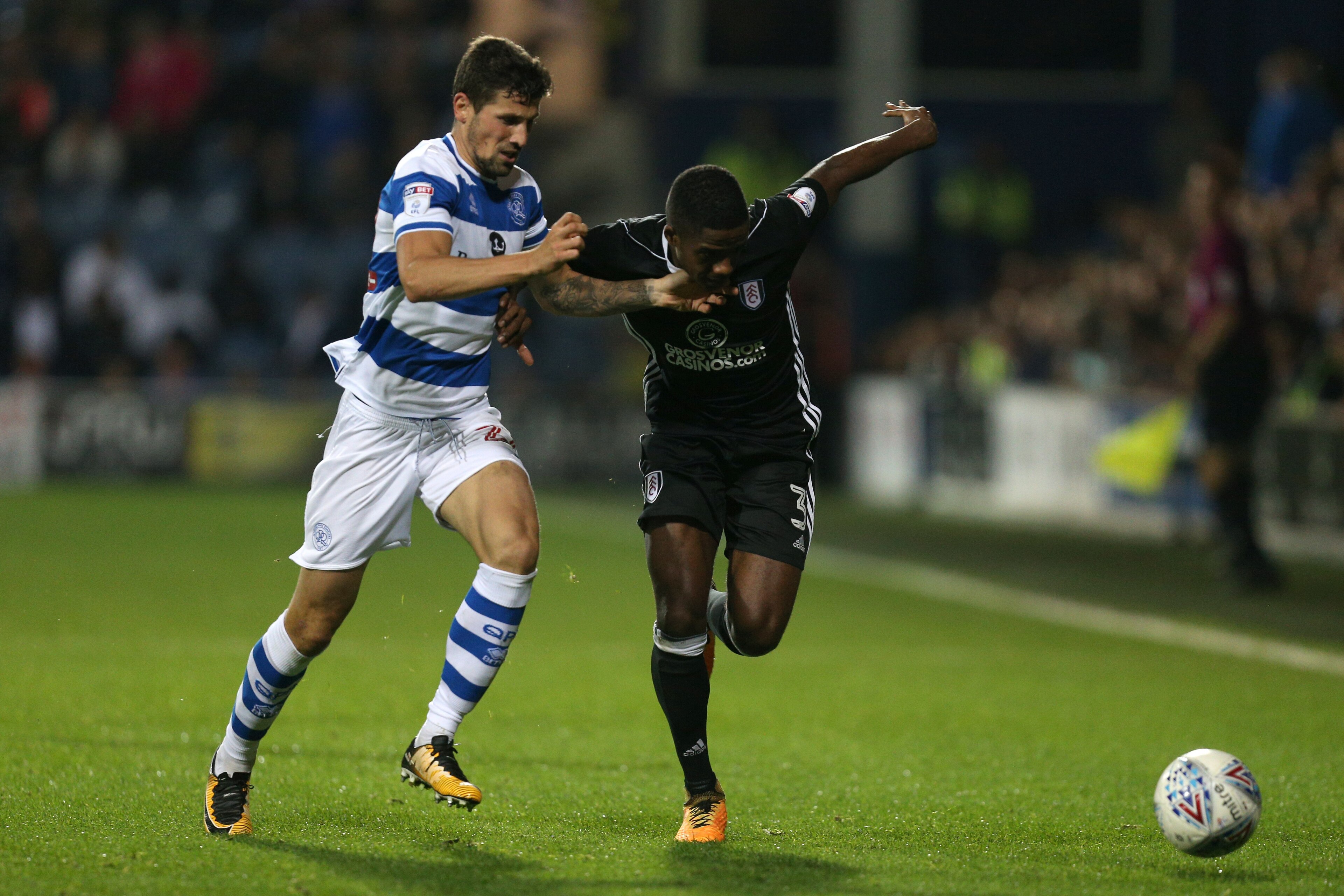 LONDON, ENGLAND - SEPTEMBER 29:  Pawel Wszolek of Queens Park Rangers and Ryan Sessegnon of Fulham battle for possession during the Sky Bet Championship match between Queens Park Rangers and Fulham at Loftus Road on September 29, 2017 in London, England. 