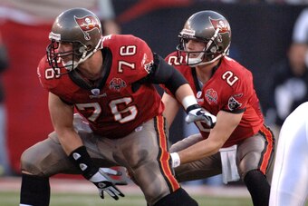 Tampa Bay Buccaneers quarterback Chris Simms takes a snap from center John Wade  against the Washington Redskins in an NFL wild card playoff game January 7, 2006 in Tampa.  The Redskins defeated the Bucs 17 - 10.  (Photo by Al Messerschmidt/Getty Images)