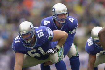14 Oct 2001:  Trent Dilfer #4 of the Seattle Seahawks stands over teammate Robbie Tobeck #61 as he signals to his team against the Denver Broncos at Husky Stadium in Seattle, Washington. The Seahawks won 34-21. DIGITAL IMAGE. Mandatory Credit: Otto Greule