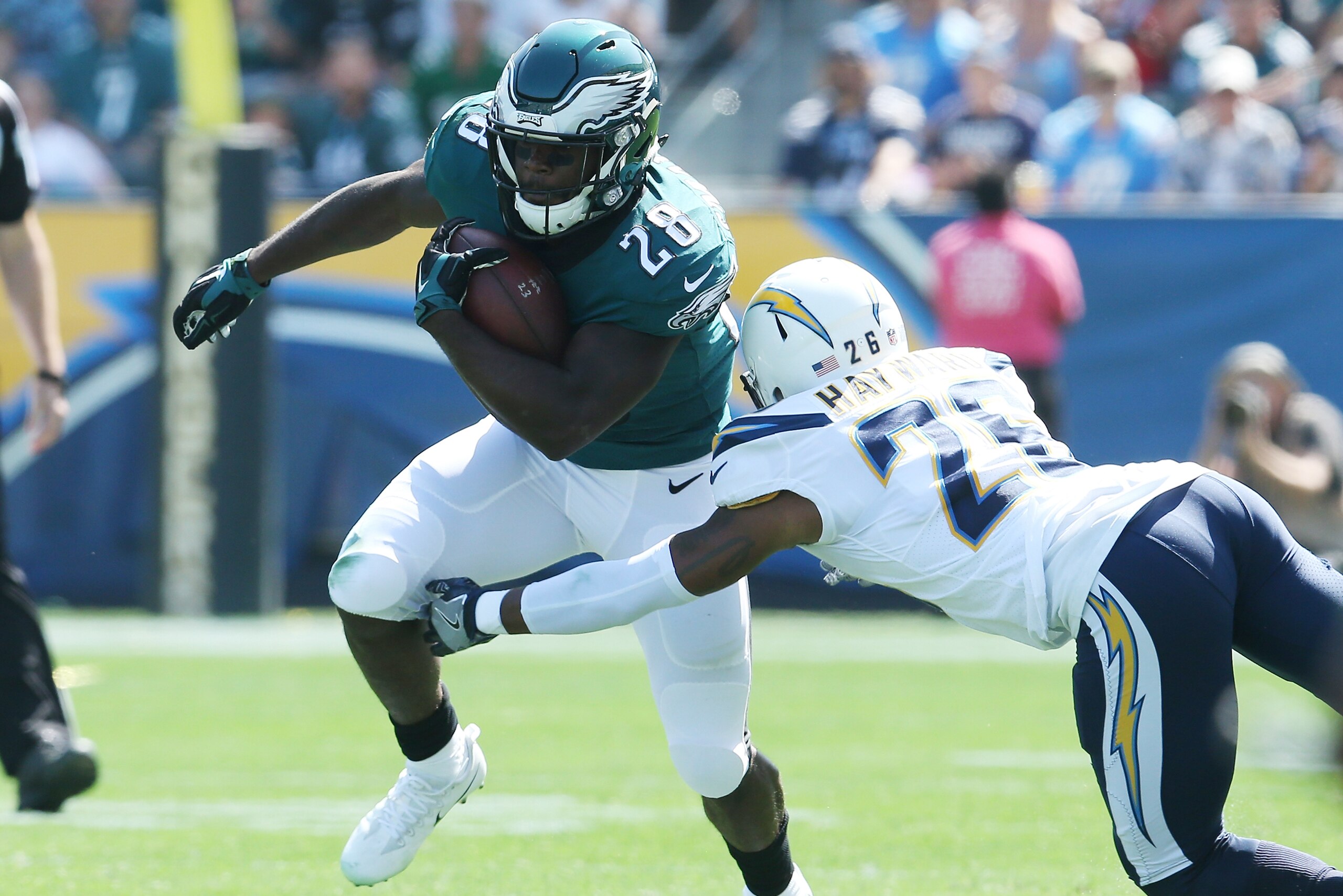CARSON, CA - OCTOBER 01:  Casey Hayward #26 of the Los Angeles Chargers tackles Wendell Smallwood #28 of the Philadelphia Eagles during the first half at the StubHub Center on October 1, 2017 in Carson, California.  (Photo by Stephen Dunn/Getty Images)