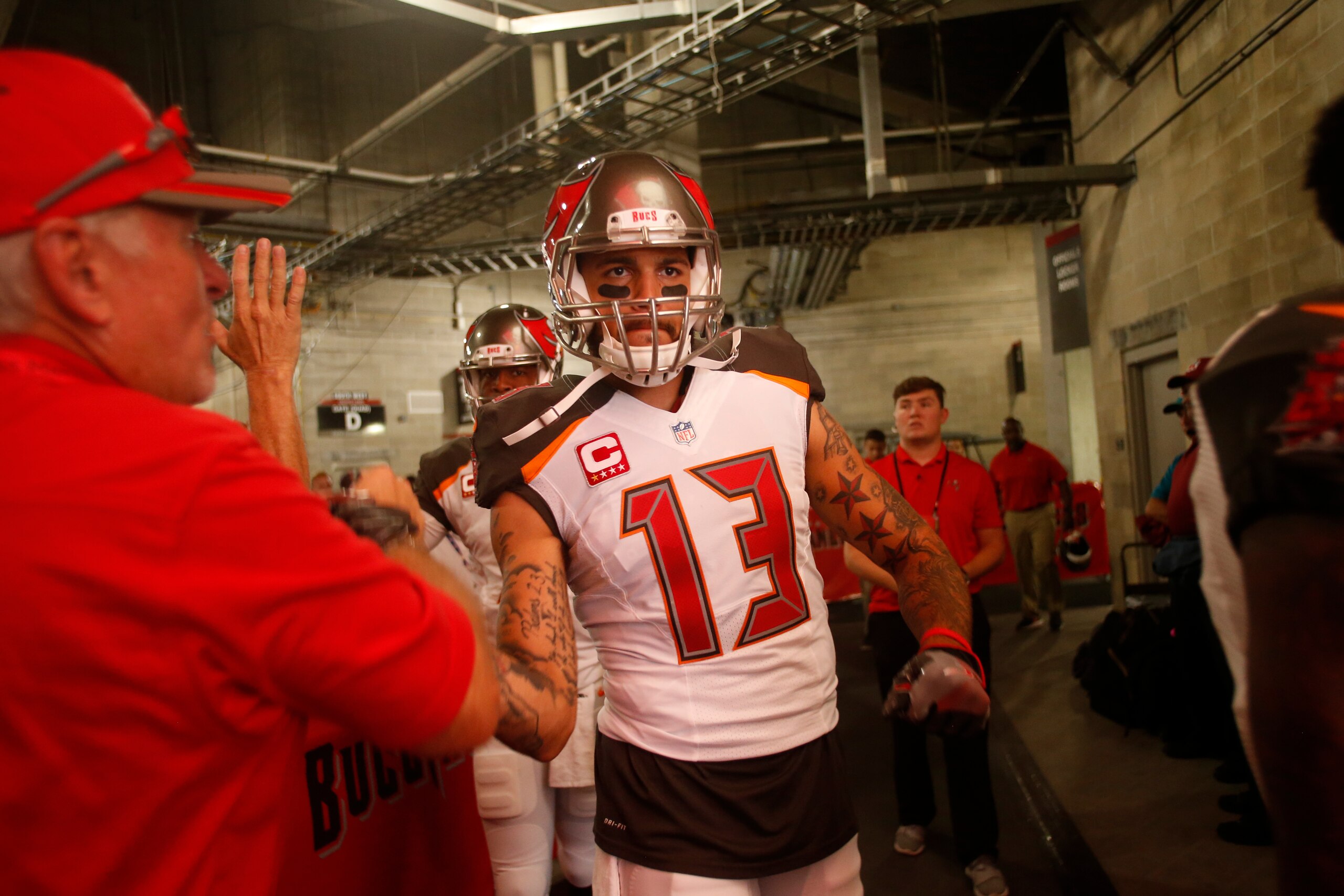 TAMPA, FL - OCTOBER 1:  Wide receiver Mike Evans #13 of the Tampa Bay Buccaneers makes his way through the tunnel before taking to the field with teammates before the start of an NFL football game against the New York Giants on October 1, 2017 at Raymond 