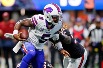 ATLANTA, GA - OCTOBER 01: Tyrod Taylor #5 of the Buffalo Bills slips away from Grady Jarrett #97 of the Atlanta Falcons and Takkarist McKinley #98 during the second half at Mercedes-Benz Stadium on October 1, 2017 in Atlanta, Georgia. (Photo by Kevin C.  