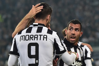 Juventus' forward from Spain Alvaro Morata is congratulated by teammates Juventus' midfielder Andrea Pirlo (hidden) and Juventus' forward from Argentina Carlos Tevez during the UEFA Champions League semi-final first leg football match Juventus vs Real Mad