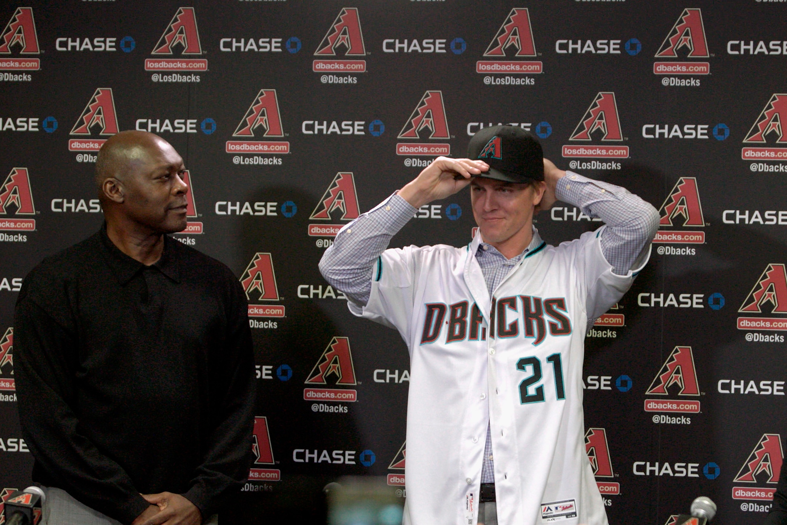 PHOENIX, AZ - DECEMBER 11: Free agent aquisition Zack Greinke of the Arizona Diamondbacks tries on his new hat as General Manager Dave Stewart looks on during a press conference at Chase Field on December 11, 2015 in Phoenix, Arizona. (Photo by Ralph Fr PHOENIX, AZ - DECEMBER 11: Free agent aquisition Zack Greinke of the Arizona Diamondbacks tries on his new hat as General Manager Dave Stewart looks on during a press conference at Chase Field on December 11, 2015 in Phoenix, Arizona. (Photo by Ralph Fr