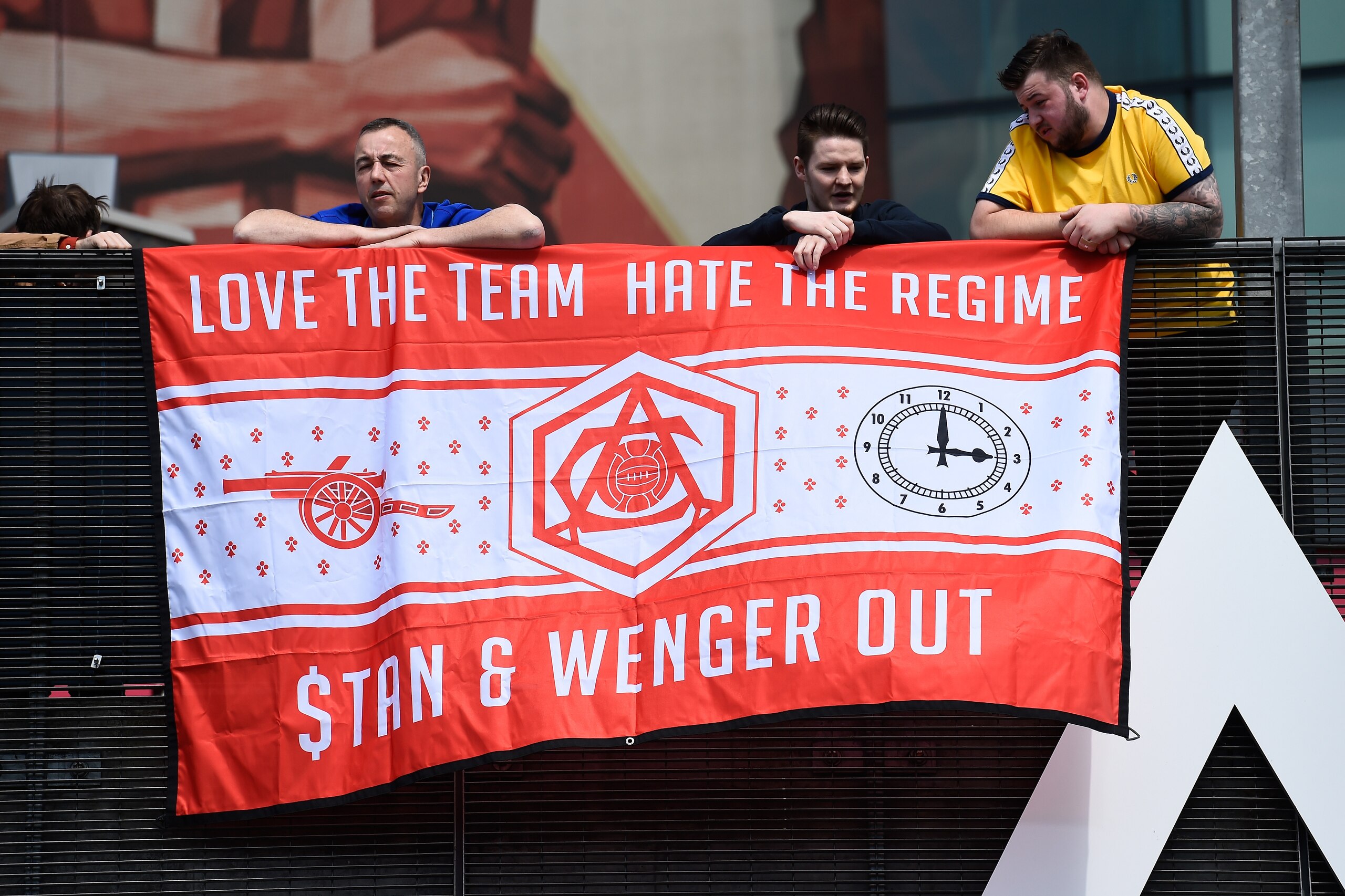 LONDON, UNITED KINGDOM - MAY 15:  Supporters hold a banner to protest against owner Stan Kroenke and manager Arsene Wenger prior to the Barclays Premier League match between Arsenal and Aston Villa at Emirates Stadium on May 15, 2016 in London, England.  