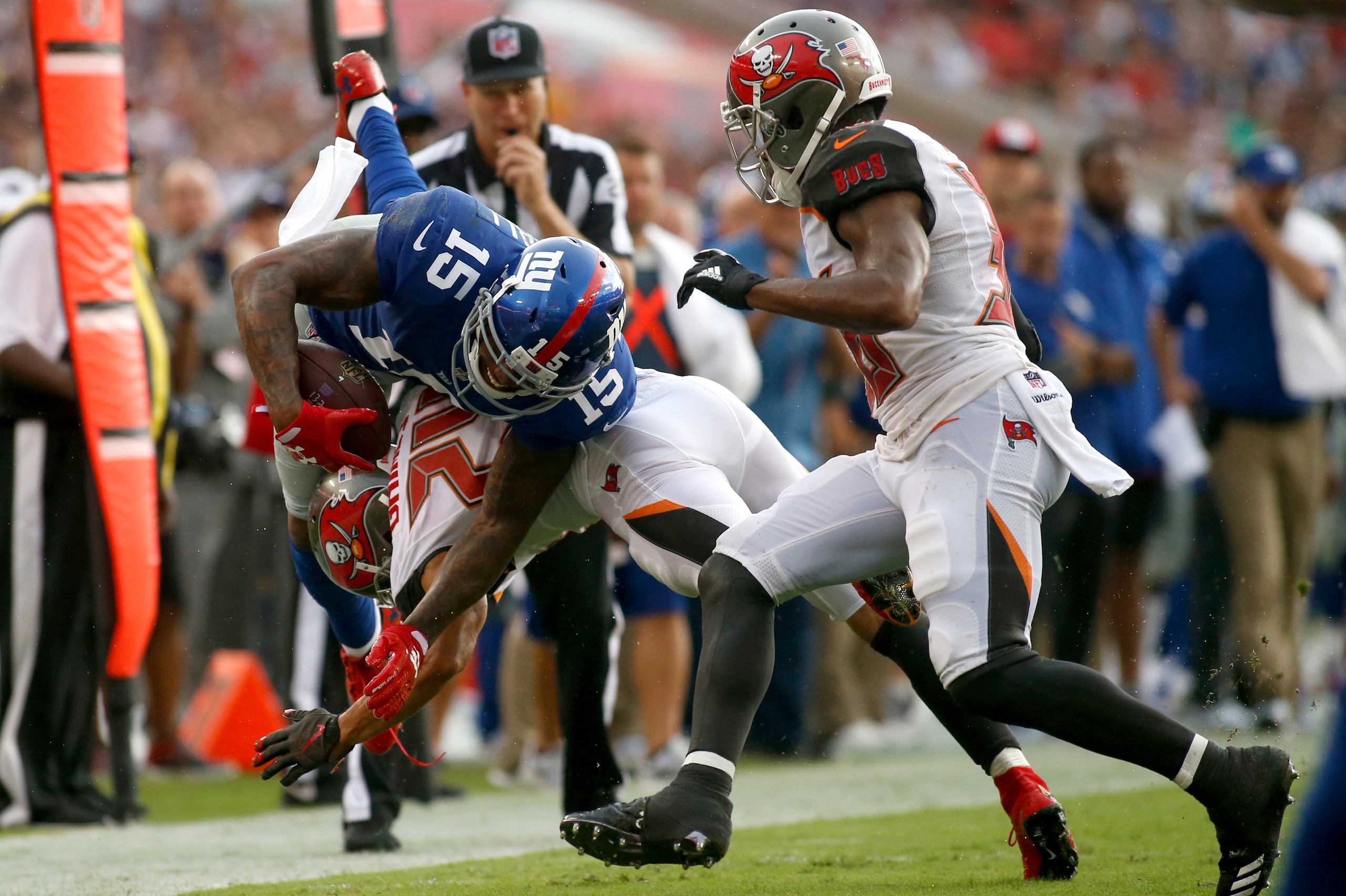 TAMPA, FL - OCTOBER 1:  Wide receiver Brandon Marshall #15 of the New York Giants is hit by cornerback Brent Grimes #24 of the Tampa Bay Buccaneers during a carry in the second quarter of an NFL football game on October 1, 2017 at Raymond James Stadium in