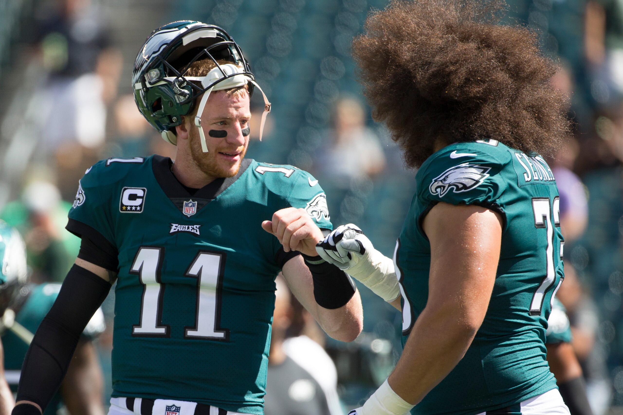 PHILADELPHIA, PA - SEPTEMBER 24: Carson Wentz #11 of the Philadelphia Eagles fist bumps with Isaac Seumalo #73 prior to the game against the New York Giants at Lincoln Financial Field on September 24, 2017 in Philadelphia, Pennsylvania. The Eagles defeate