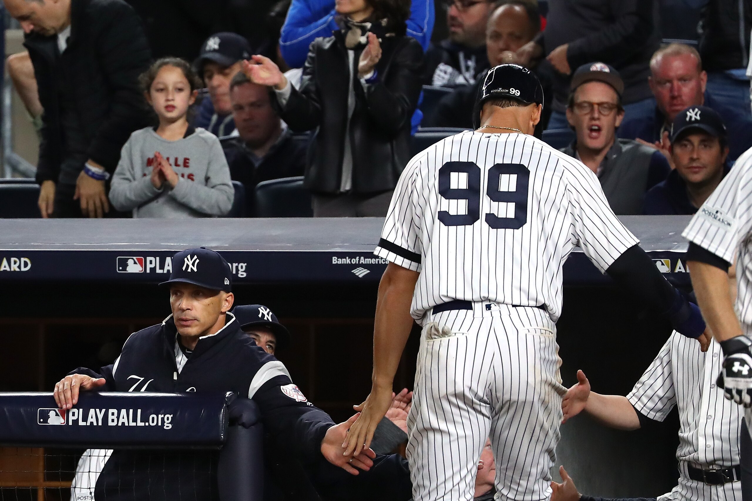 NEW YORK, NY - OCTOBER 03:  Manager Joe Girardi #28 high fives Aaron Judge #99 of the New York Yankees after scoring on a  bases loaded Aaron Hicks #31 walk by the Minnesota Twins during the seventh inning in the American League Wild Card Game at Yankee S