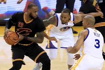 OAKLAND, CA - JUNE 12:  Andre Iguodala #9 and David West #3 of the Golden State Warriors defends LeBron James #23 of the Cleveland Cavaliers in Game 5 of the 2017 NBA Finals at ORACLE Arena on June 12, 2017 in Oakland, California. NOTE TO USER: User expre