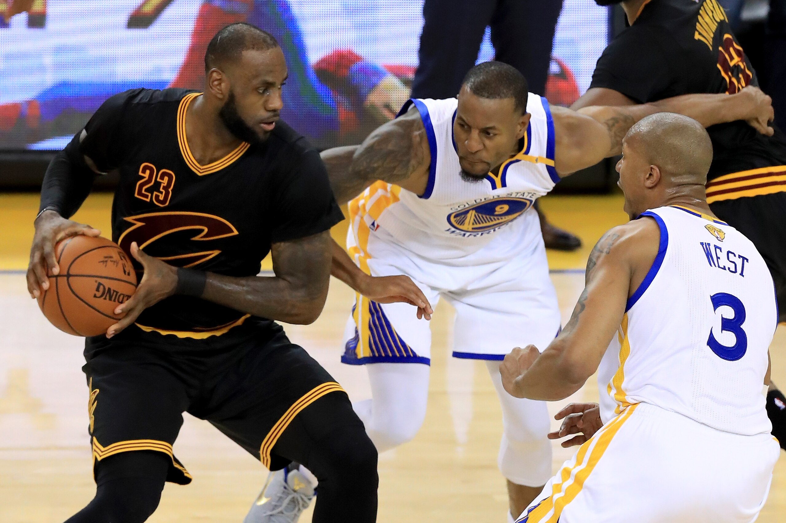 OAKLAND, CA - JUNE 12:  Andre Iguodala #9 and David West #3 of the Golden State Warriors defends LeBron James #23 of the Cleveland Cavaliers in Game 5 of the 2017 NBA Finals at ORACLE Arena on June 12, 2017 in Oakland, California. NOTE TO USER: User expre