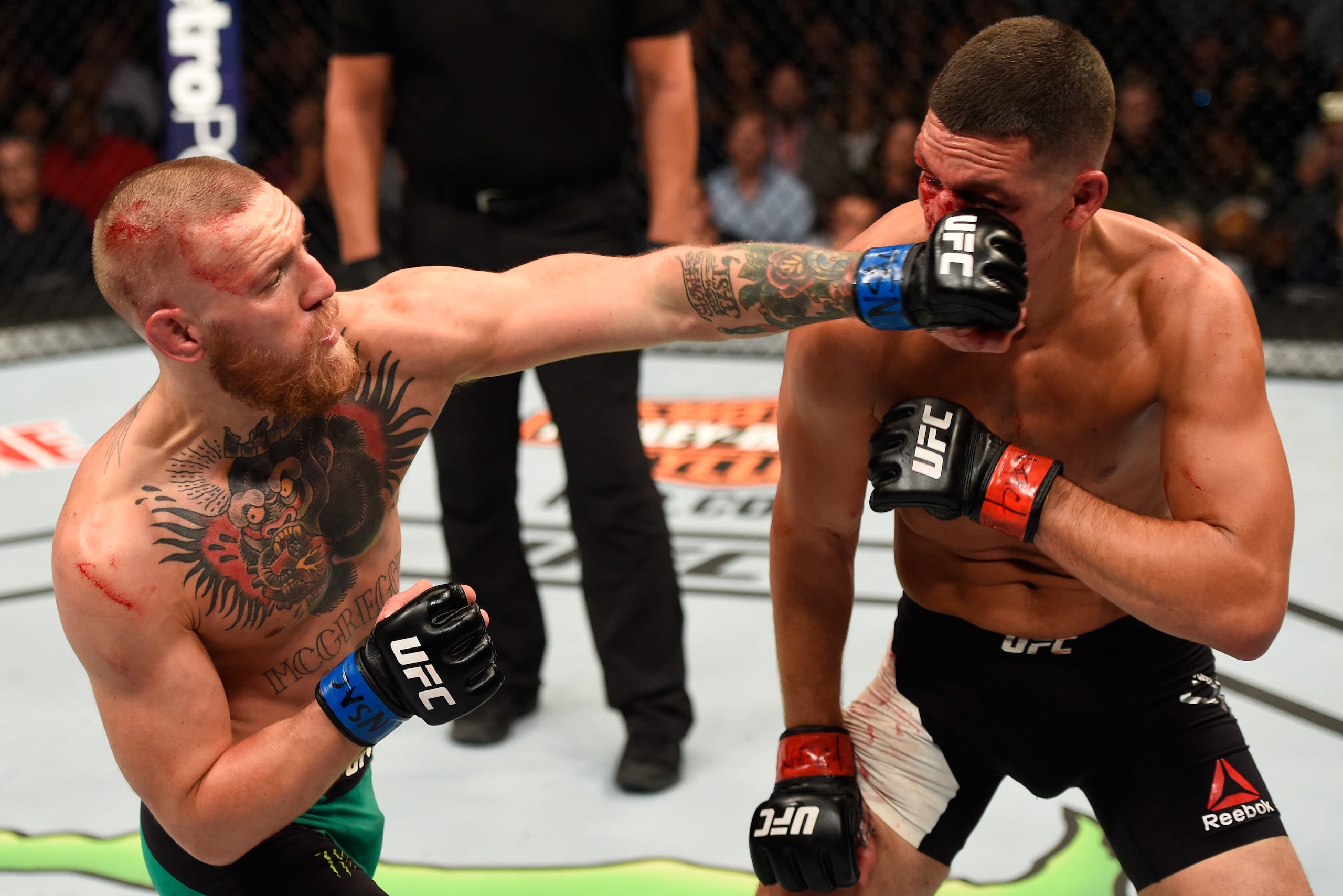 LAS VEGAS, NV - AUGUST 20:   (L-R) Conor McGregor of Ireland punches Nate Diaz in their welterweight bout during the UFC 202 event at T-Mobile Arena on August 20, 2016 in Las Vegas, Nevada. (Photo by Josh Hedges/Zuffa LLC/Zuffa LLC via Getty Images)