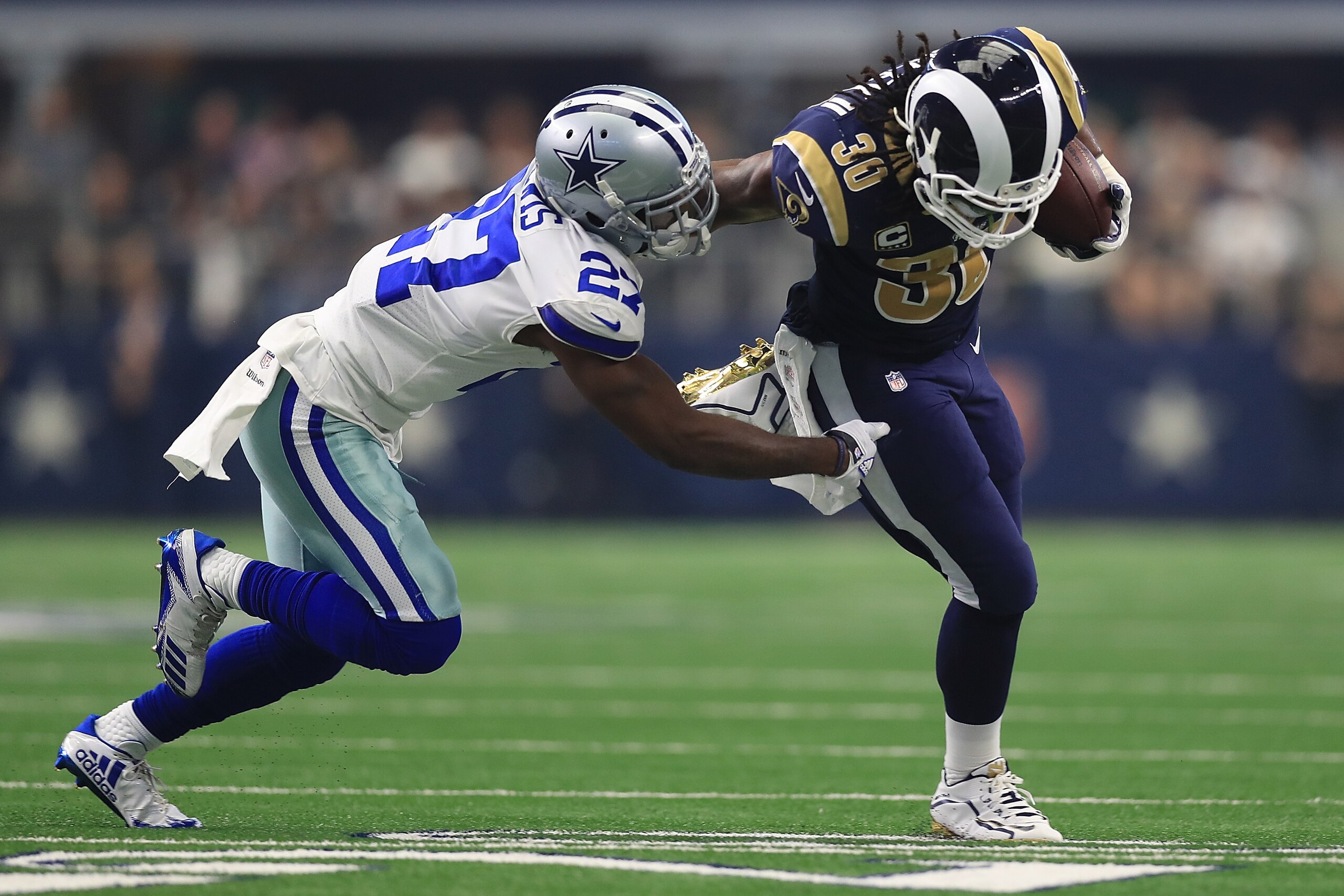 ARLINGTON, TX - OCTOBER 01:  Jourdan Lewis #27 of the Dallas Cowboys pursues Todd Gurley #30 of the Los Angeles Rams in the first half of a game  at AT&T Stadium on October 1, 2017 in Arlington, Texas.  (Photo by Ronald Martinez/Getty Images)