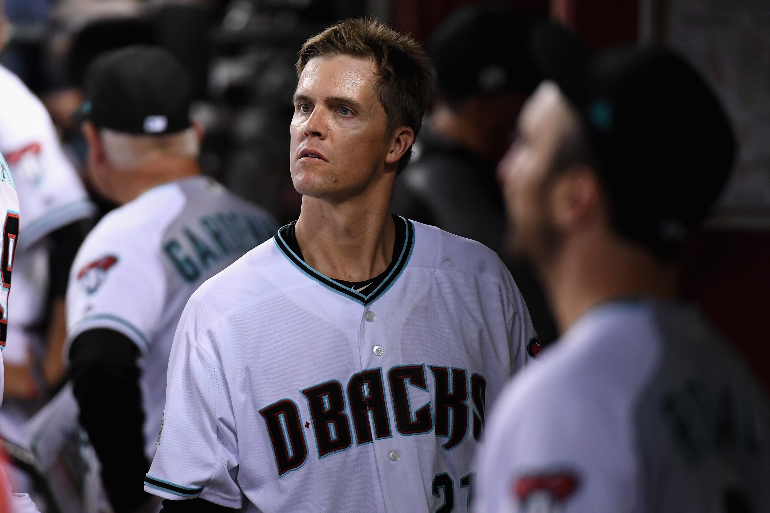 PHOENIX, AZ - OCTOBER 04: Zack Greinke #21 of the Arizona Diamondbacks watches the action after being removed from the game in the top of the fourth inning of the National League Wild Card game against the Colorado Rockies at Chase Field on October 4, 201