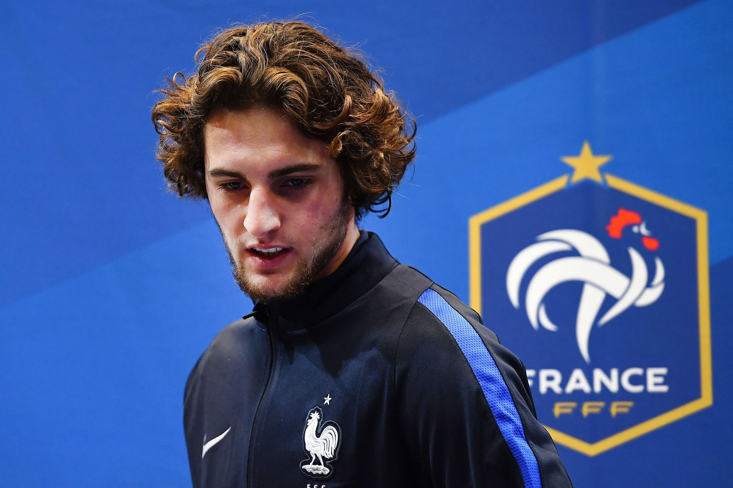 France's midfielder Adrien Rabiot arrives to attend a press conference in Clairefontaine-en-Yvelines, near Paris, on November 8, 2016, on the team's preparation for the upcoming World Cup 2018 football qualifiers. 
With seven points from three games Franc