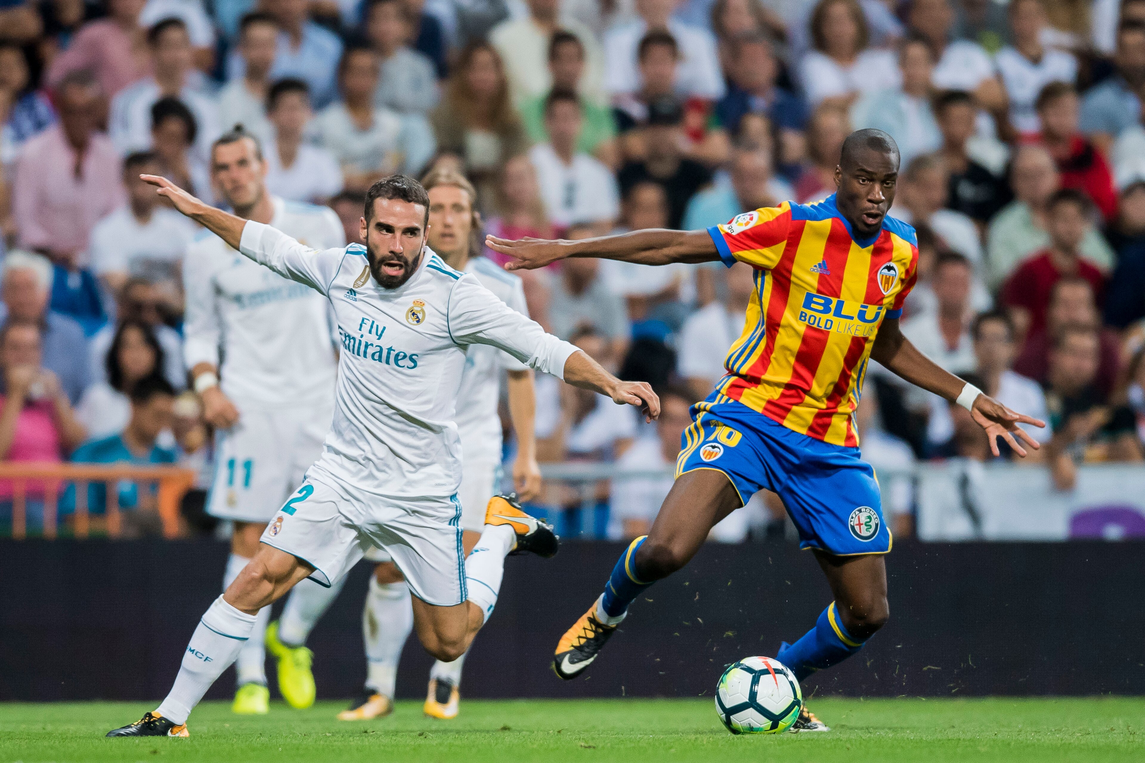 MADRID, SPAIN - AUGUST 27: Daniel Carvajal Ramos (l) of Real Madrid competes for the ball with Geoffrey Kondogbia of Valencia CF during their La Liga 2017-18 match between Real Madrid and Valencia CF at the Estadio Santiago Bernabeu on 27 August 2017 in M