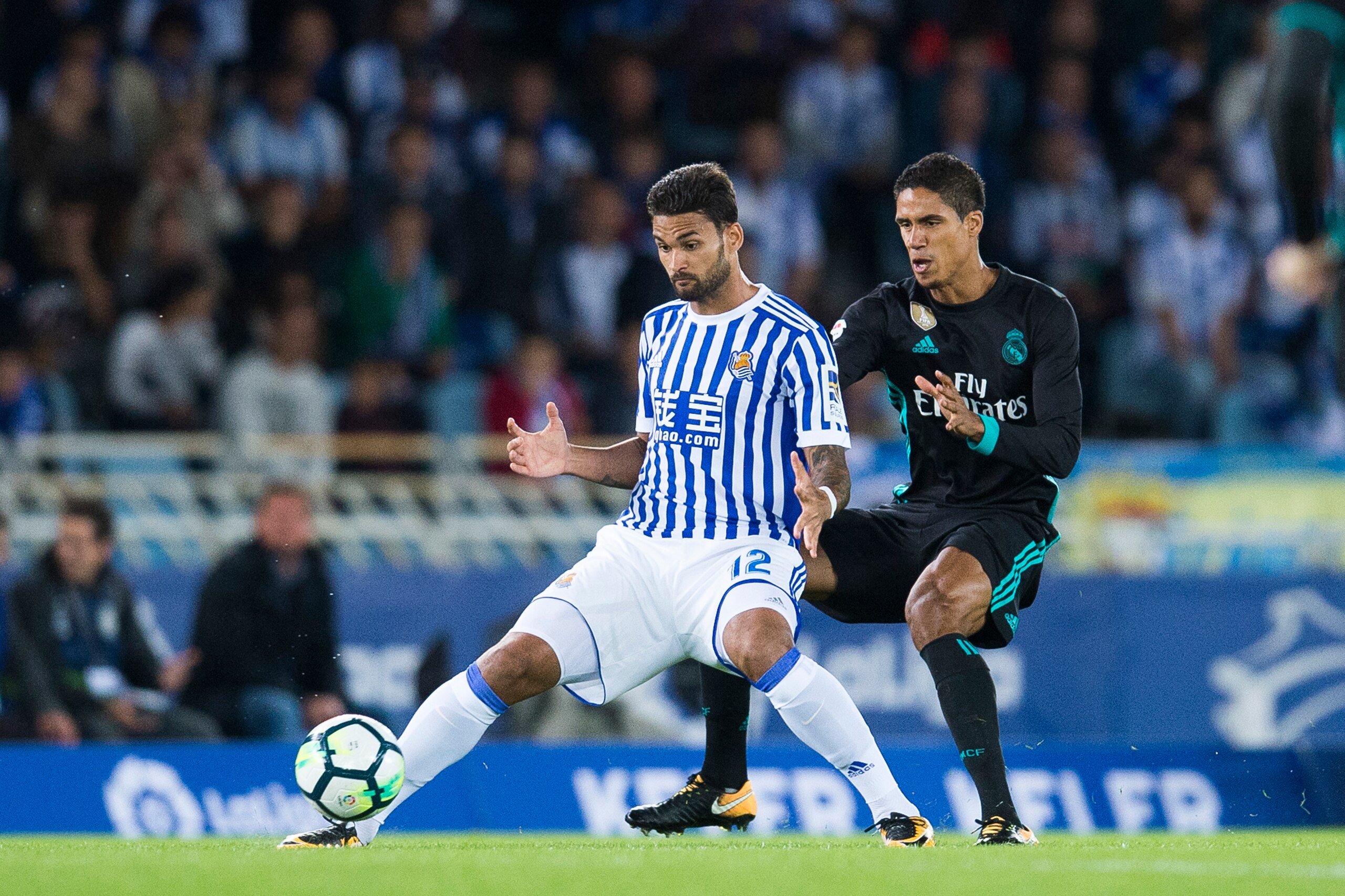 SAN SEBASTIAN, SPAIN - SEPTEMBER 17: Raphael Varane of Real Madrid duels for the ball with Willian Jose Da Silva of Real Sociedad during the La Liga match between Real Sociedad de Futbol and Real Madrid at Estadio Anoeta on September 17, 2017 in San Sebas