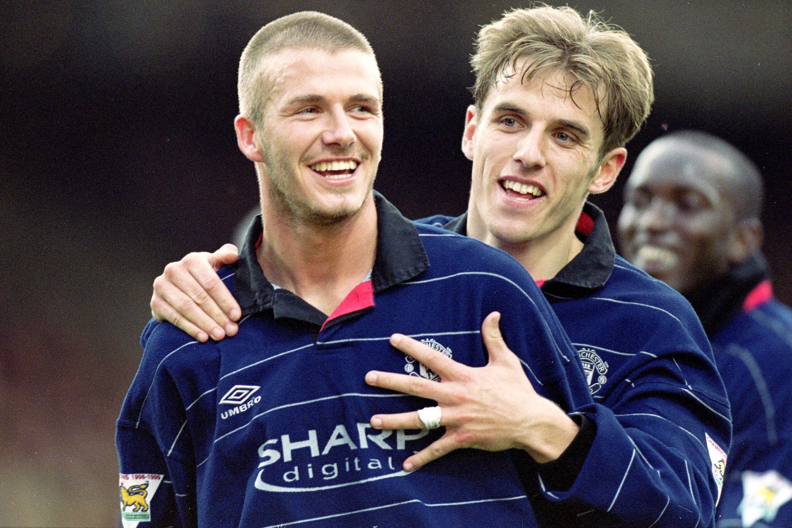 25 Mar 2000:  David Beckham of Manchester United is congratulated by teammate Phil Neville during the FA Carling Premiership match against Bradford City at Valley Parade in Bradford, England.  Manchester United won the match 4-0. \ Mandatory Credit:  Mich