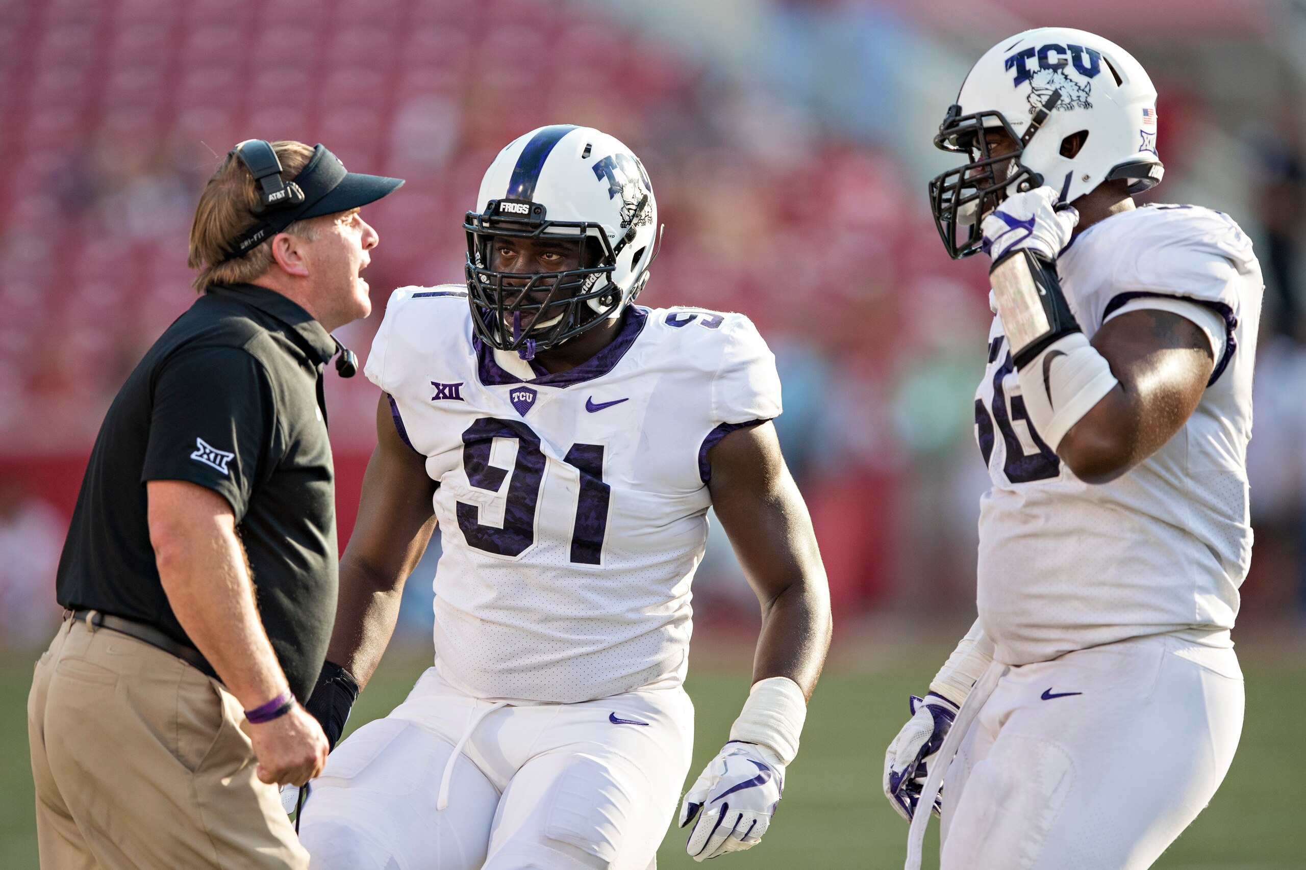 FAYETTEVILLE, AR - SEPTEMBER 9:  Head Coach Gary Patterson gives instructions to L.J. Collier #91 and Chris Bradley #56 of the TCU Horned Frogs during a game against the Arkansas Razorbacks at Donald W. Reynolds Razorback Stadium on September 9, 2017 in F