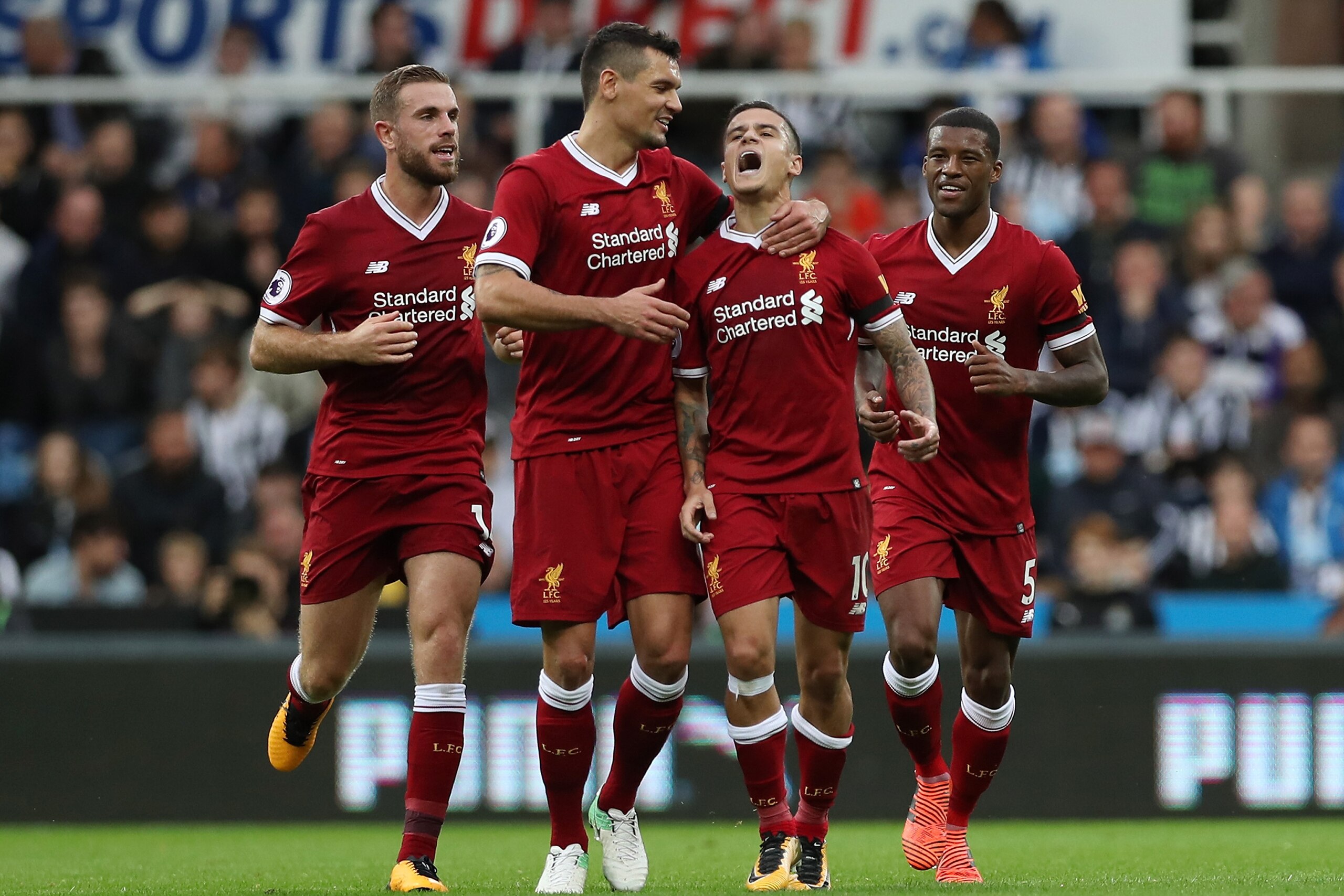 NEWCASTLE UPON TYNE, ENGLAND - OCTOBER 01:  Philippe Coutinho of Liverpool celebrates scoring his sides first goal with Dejan Lovren of Liverpool during the Premier League match between Newcastle United and Liverpool at St. James Park on October 1, 2017 i