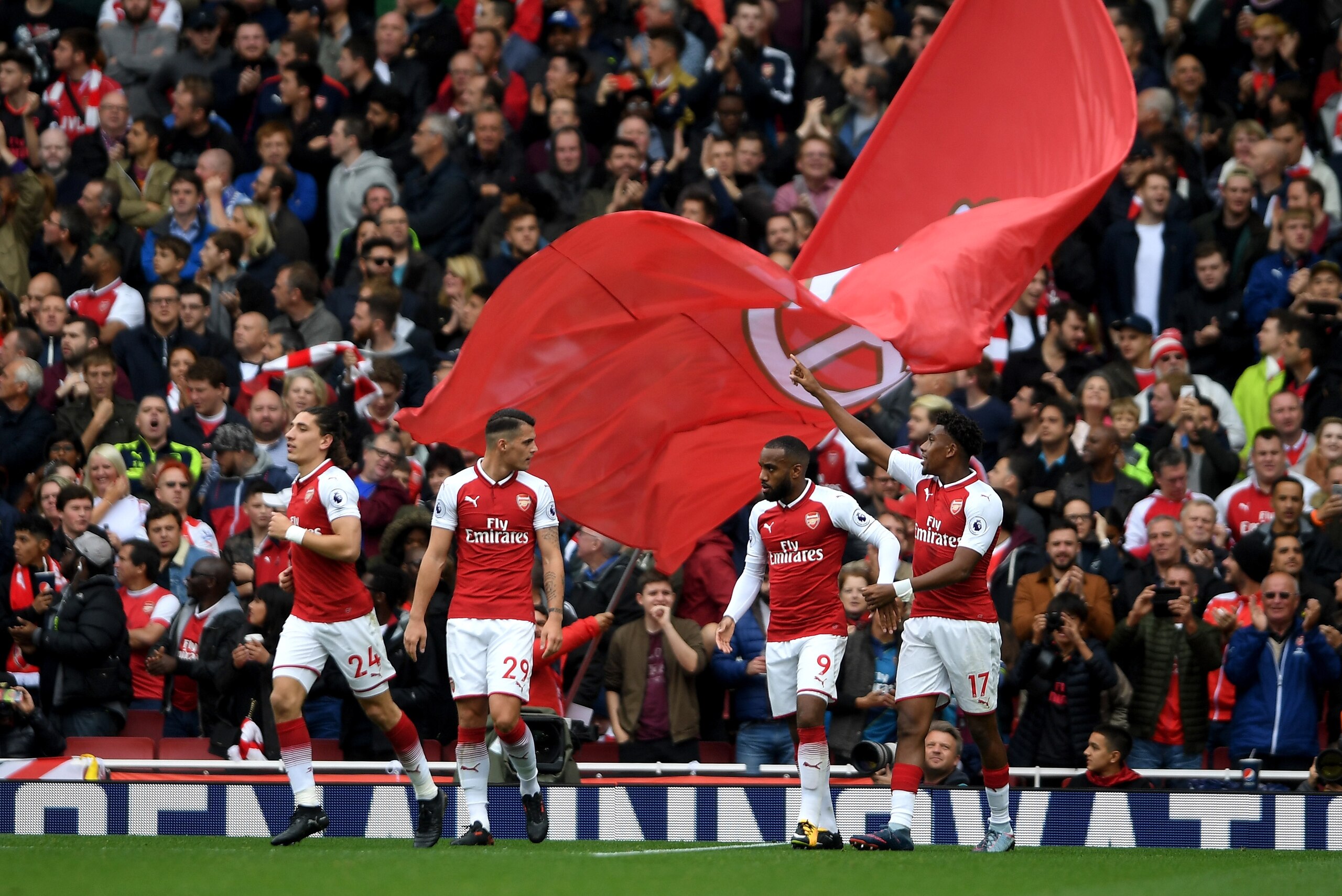 LONDON, ENGLAND - OCTOBER 01: Alex Iwobi of Arsenal celebrates scoring his sides second goal with his Arsenal team mates during the Premier League match between Arsenal and Brighton and Hove Albion at Emirates Stadium on October 1, 2017 in London, England