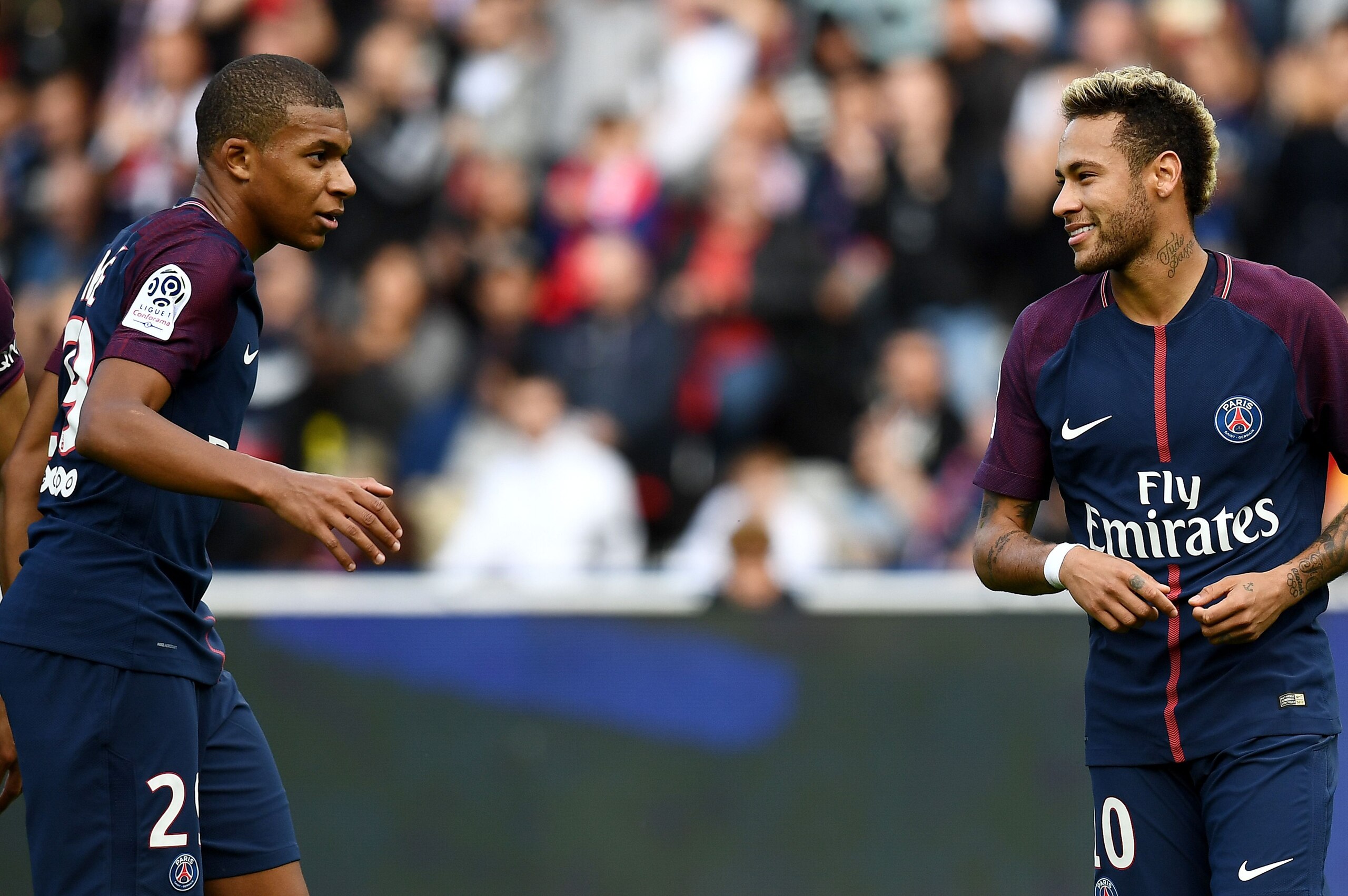 Paris Saint-Germain's Brazilian forward Neymar (R) reacts with Paris Saint-Germain's French forward Kylian M'Bappe  during the French Ligue 1 football match between Paris Saint-Germain and Bordeaux at the Parc des Princes stadium in Paris, on September 30